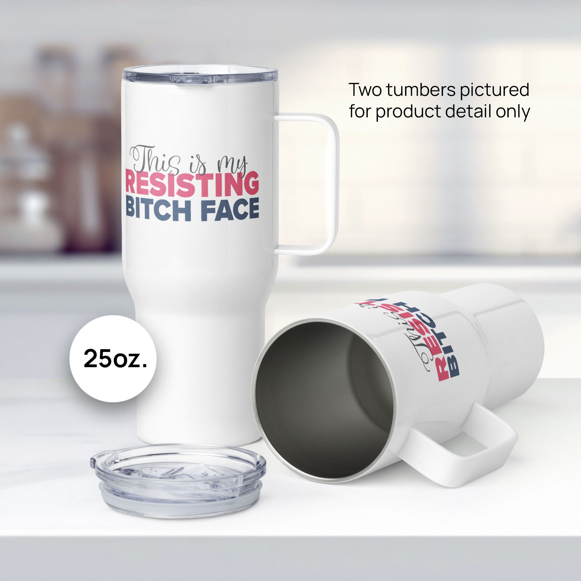 Two 25 ounce white insulated travel tumblers with the phrase “This Is My Resisting Bitch Face” printed in script and bold text, resting on a kitchen counter, showing detail.