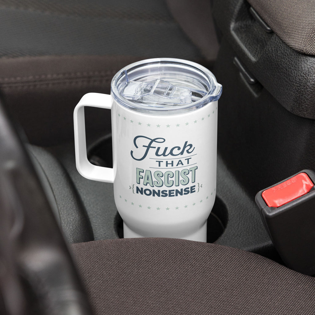 White insulated travel tumbler with handle featuring the bold quote “Fuck That Fascist Nonsense” in blue and mint green text, in a car cup holder.