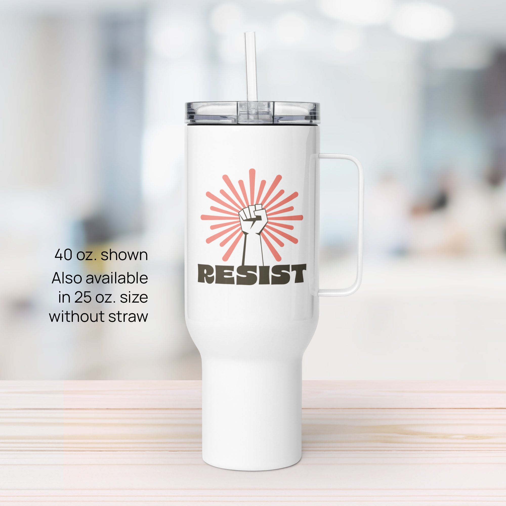 40 ounce white stainless steel tumbler with handle, with graphic text "resist" below a raised fist and coral color burst.