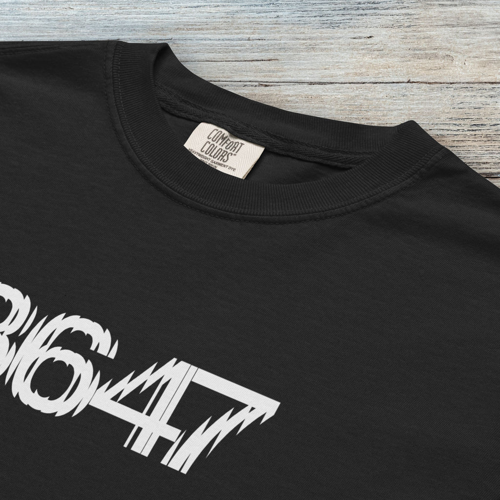 Closeup detail of black unisex t-shirt featuring the number “8647” in bold, clean typography with glass block effect, referencing Trump impeachment.