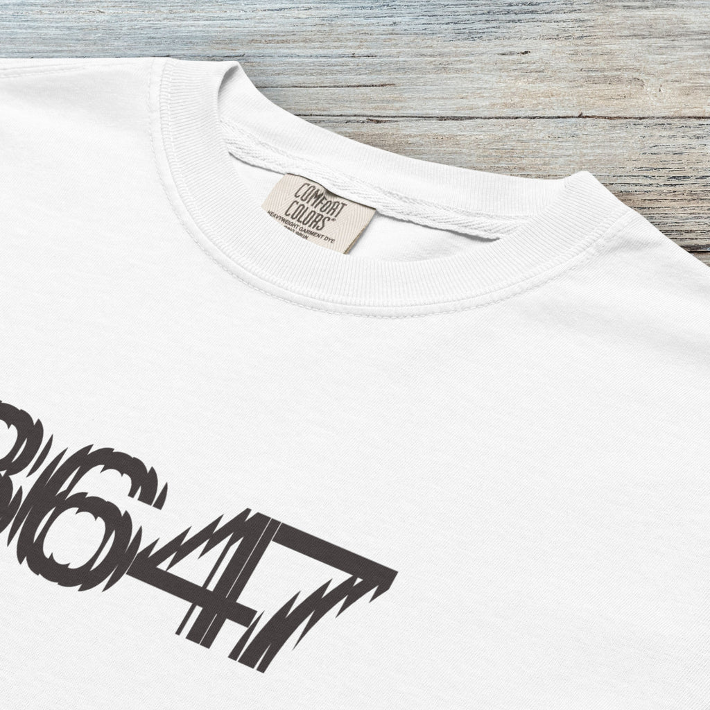 Closeup detail of white unisex t-shirt featuring the number “8647” in bold, clean typography with glass block effect, referencing Trump impeachment.