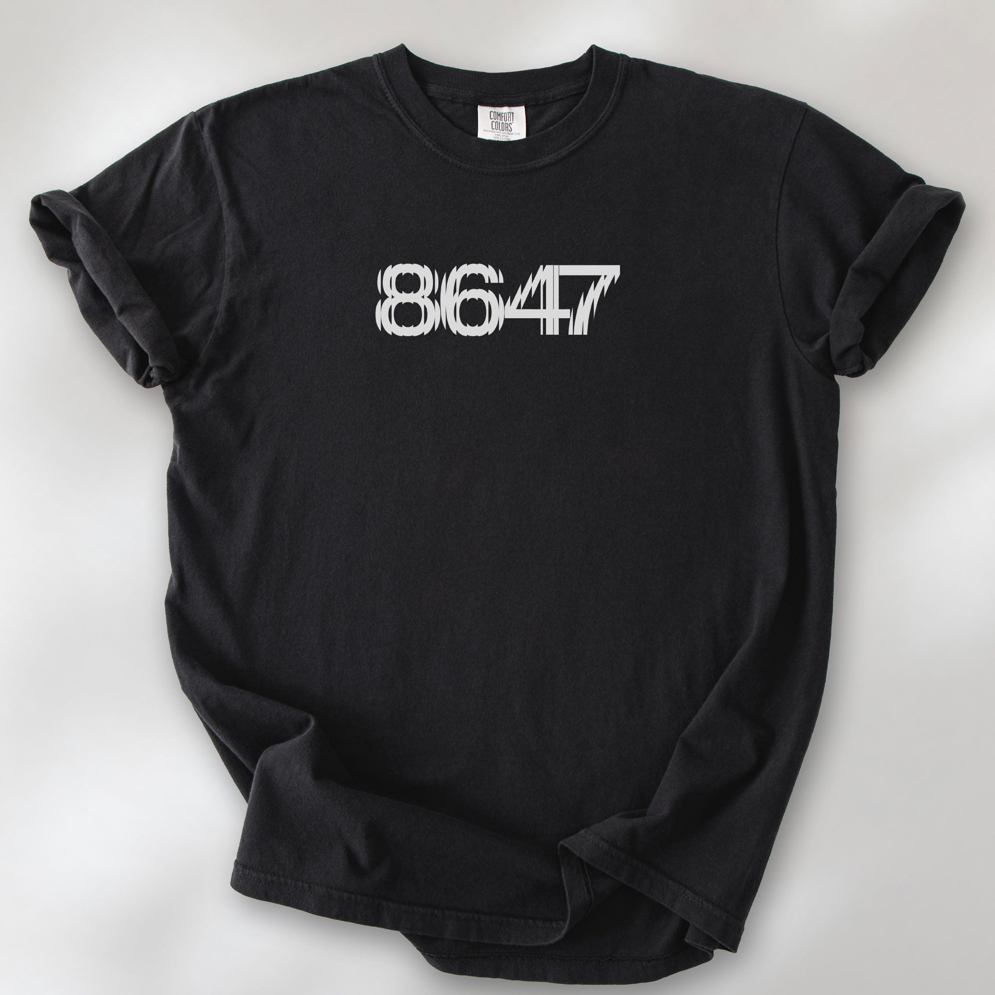 Black t-shirt featuring the number “8647” in bold, clean typography with glass block effect.