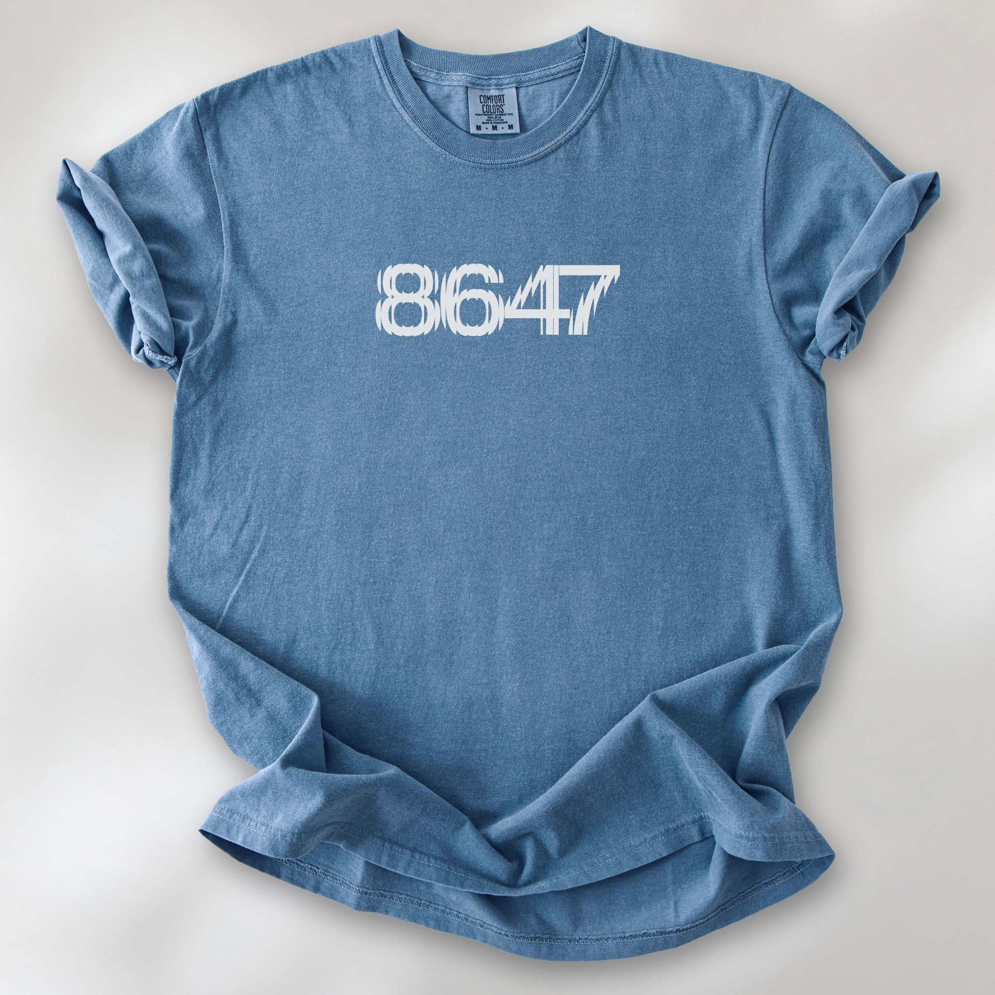 Blue jean t-shirt featuring the number “8647” in bold, clean typography with glass block effect.
