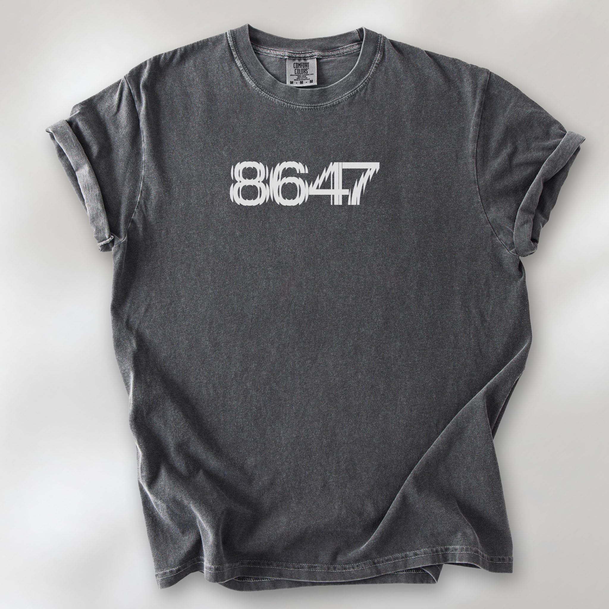 Pepper unisex t-shirt featuring the number “8647” in bold, clean typography with glass block effect, referencing Trump impeachment.