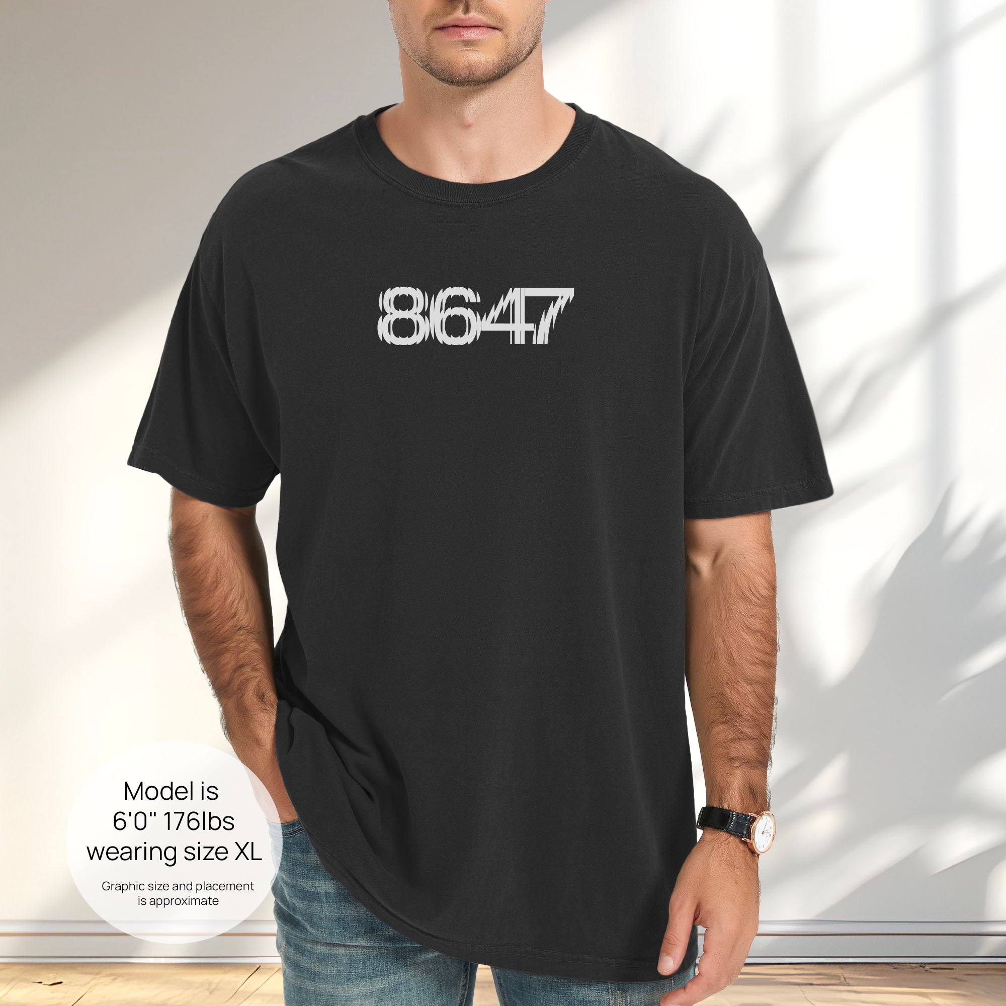 Male model wearing black t-shirt featuring the number “8647” in bold, clean typography with glass block effect. Includes size and fit information for the model who is 6 feet 0 inches, 176 pounds, and wearing a size XL shirt.
