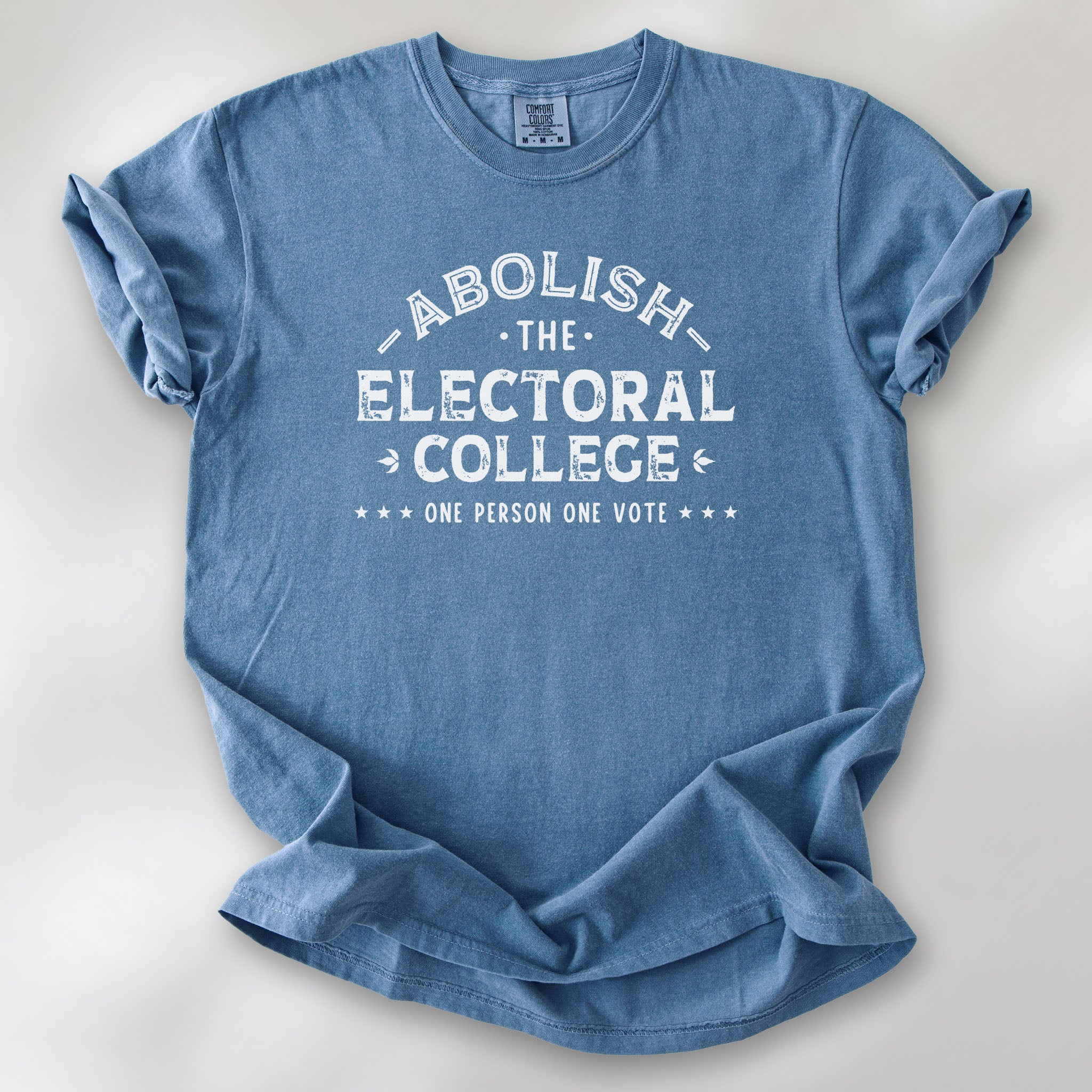 Blue jean t-shirt with distressed text reading “Abolish the Electoral College One Person One Vote” in vintage style design