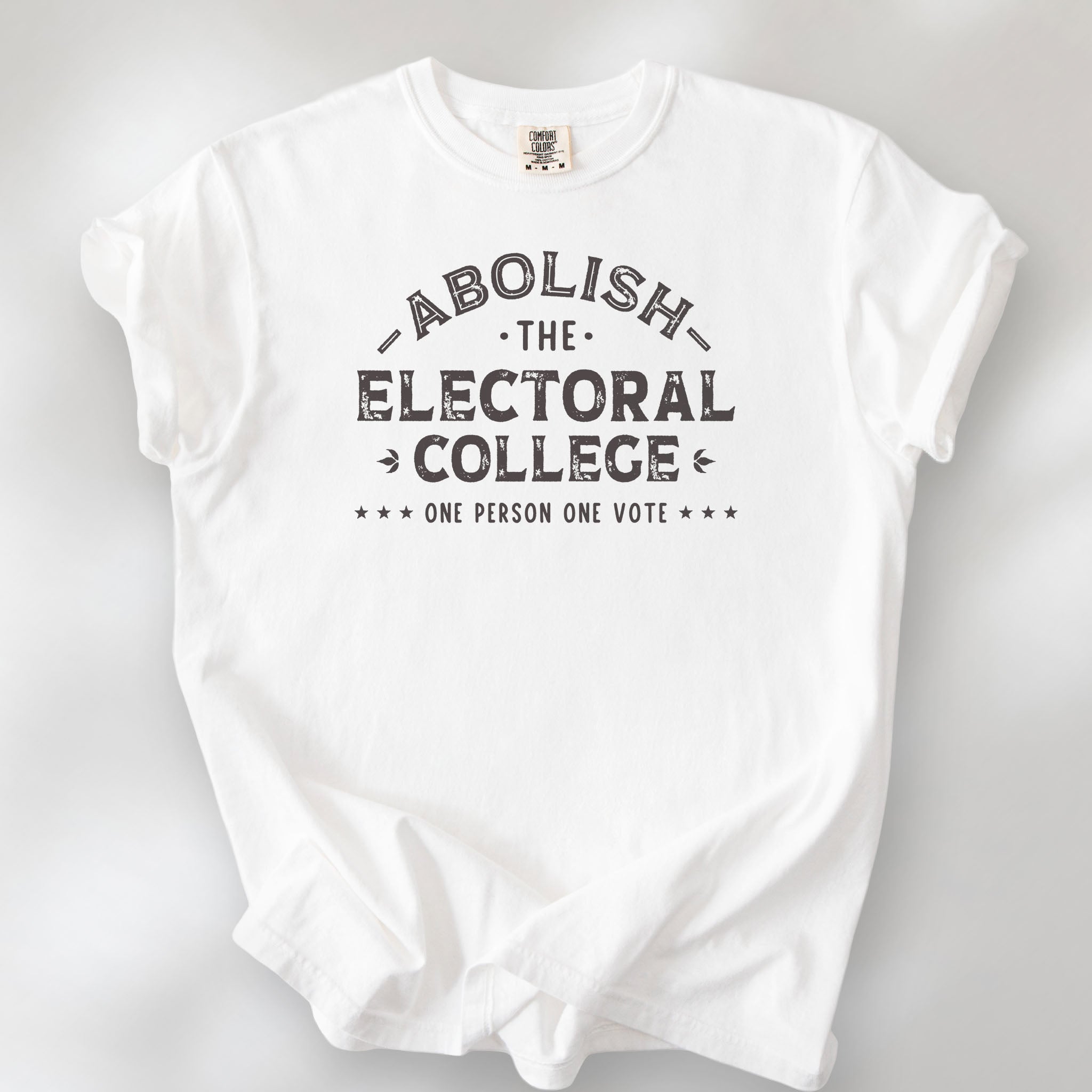 White t-shirt with distressed text reading “Abolish the Electoral College One Person One Vote” in vintage style design