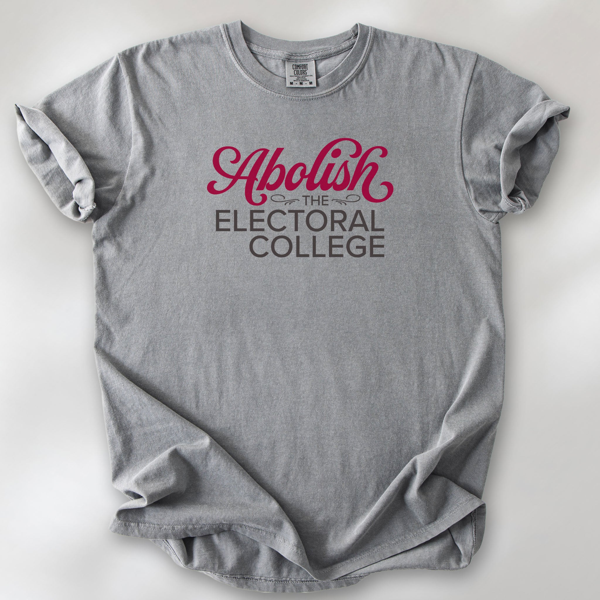 Grey t-shirt with stylized text reading “Abolish the Electoral College” in muted red and gray.
