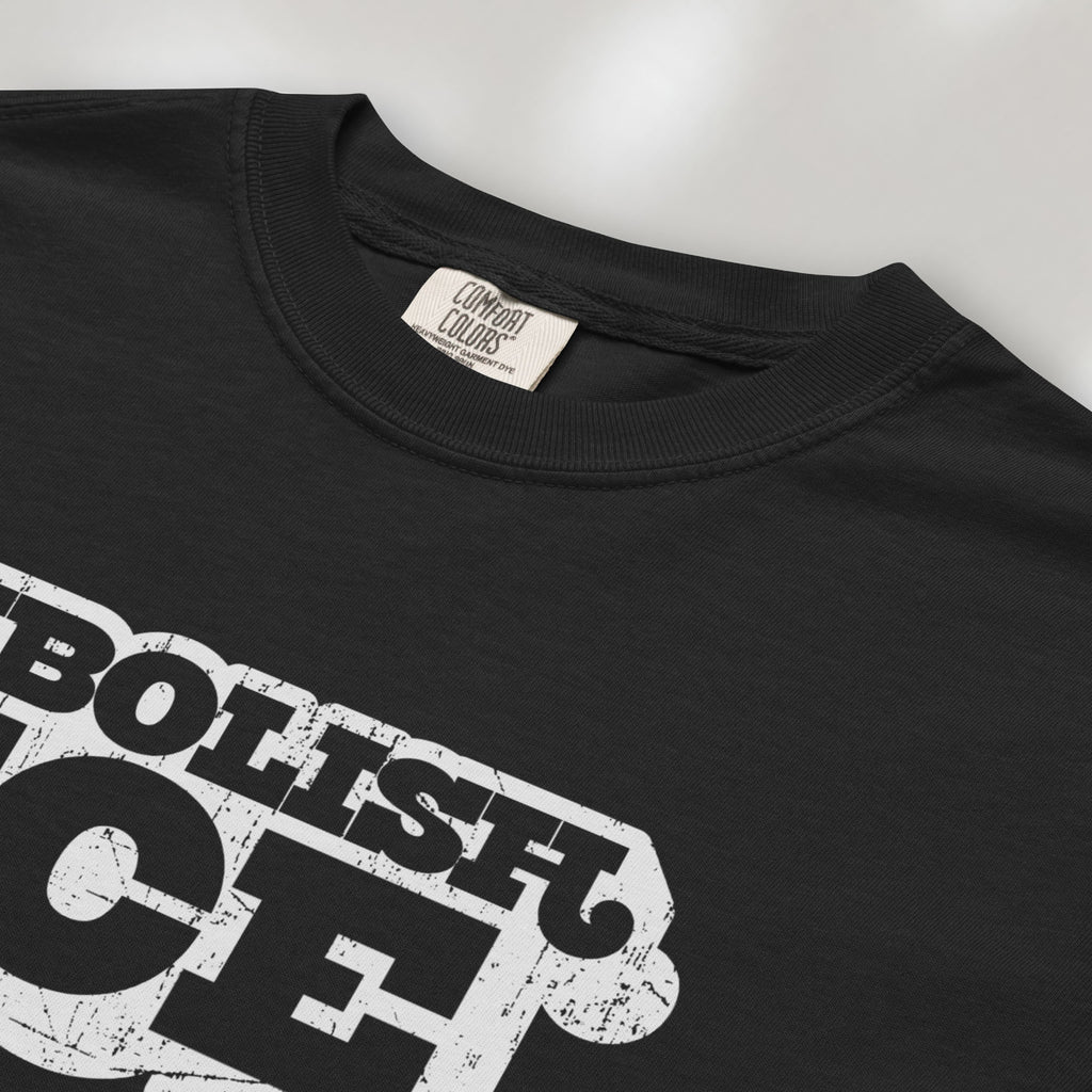 Closeup detail of black t-shirt with retro distressed text reading “Abolish ICE” for immigration justice and anti-ICE activism.