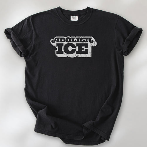 Black t-shirt with retro distressed text reading “Abolish ICE” for immigration justice and anti-ICE activism.
