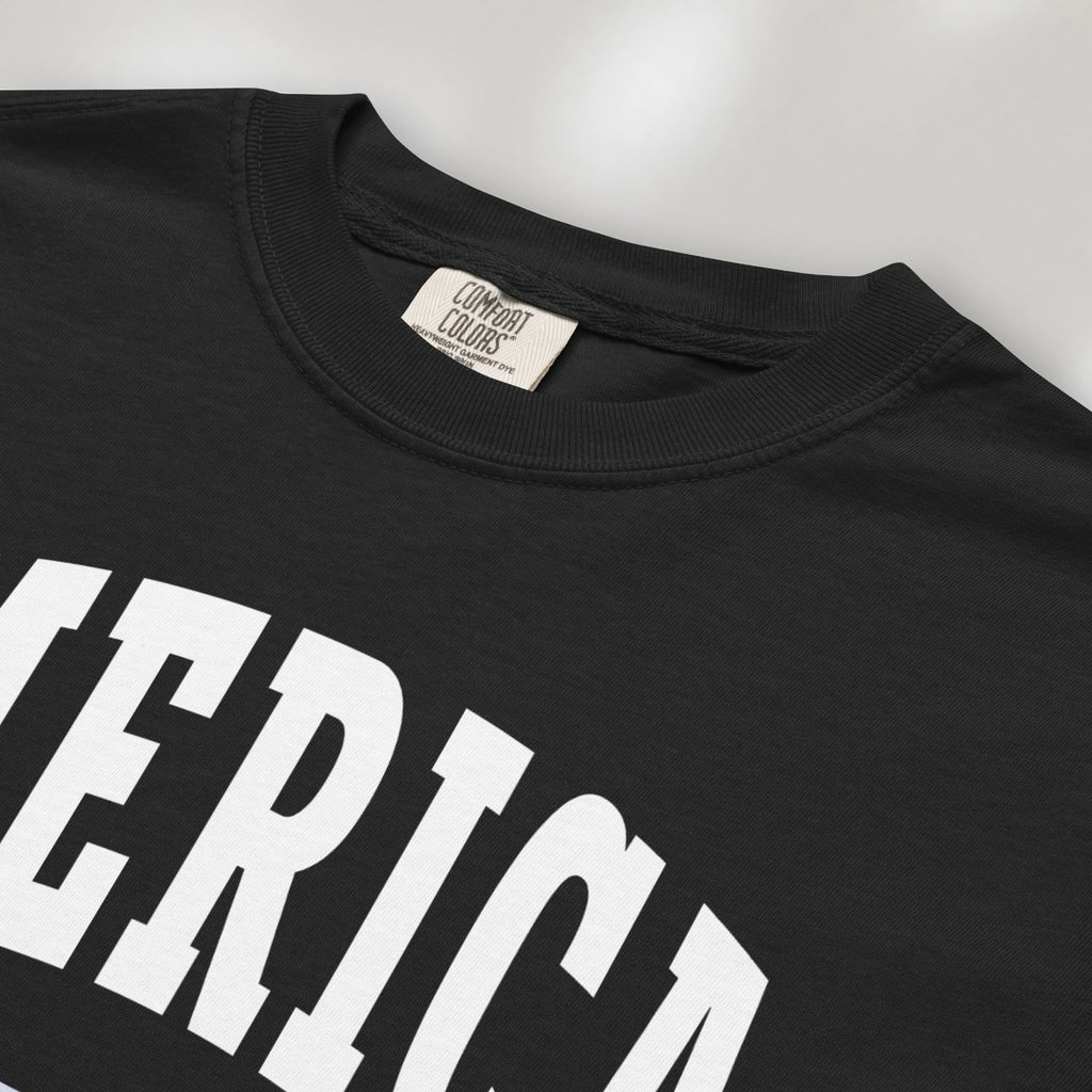 Closeup detail of black t-shirt with bold varsity text reading “America 250 — Est. 1776” in varsity style design.