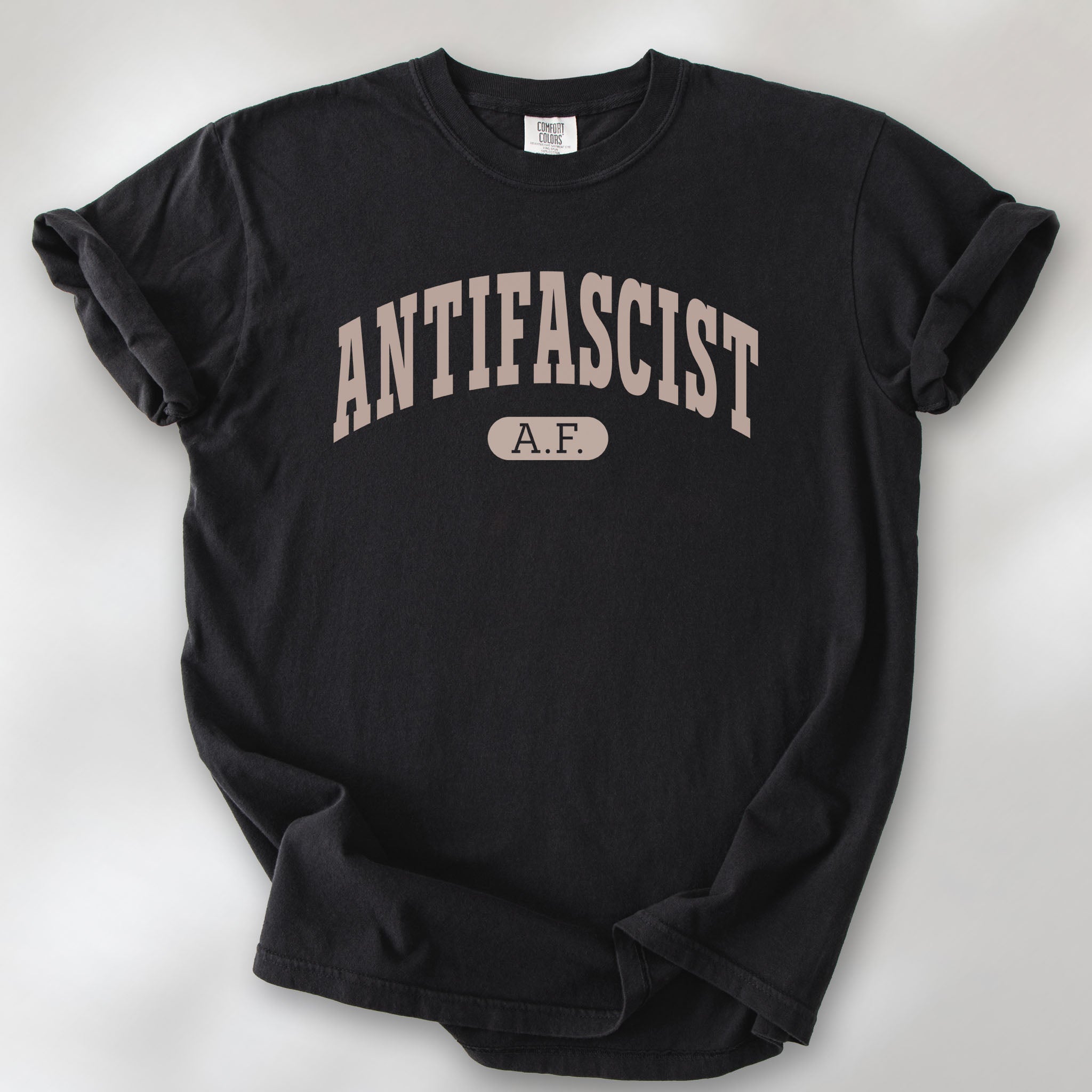 Black Comfort Colors t-shirt with varsity collegiate style text across the front that reads "Antifascist AF."