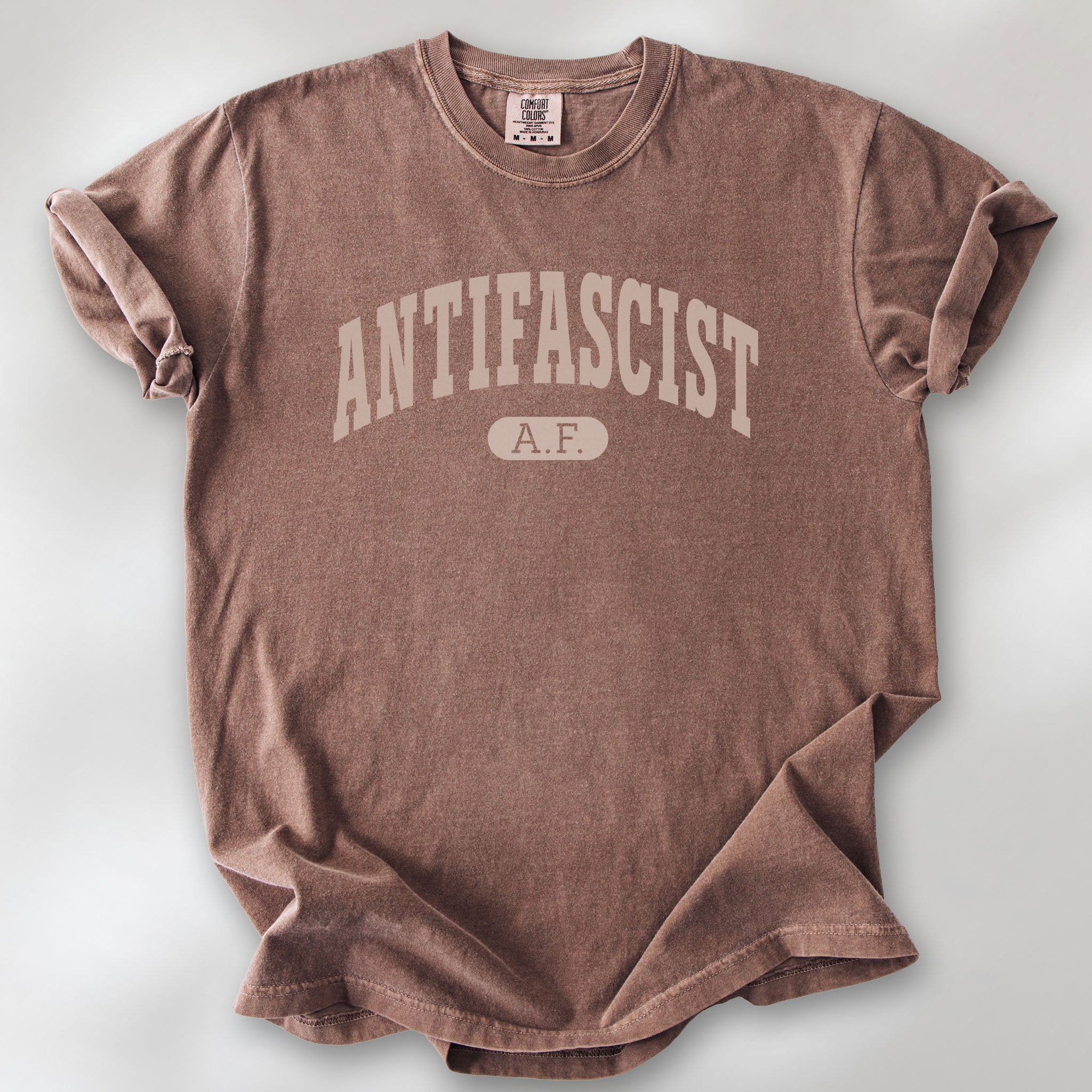 Espresso Comfort Colors t-shirt with varsity collegiate style text across the front that reads "Antifascist AF."