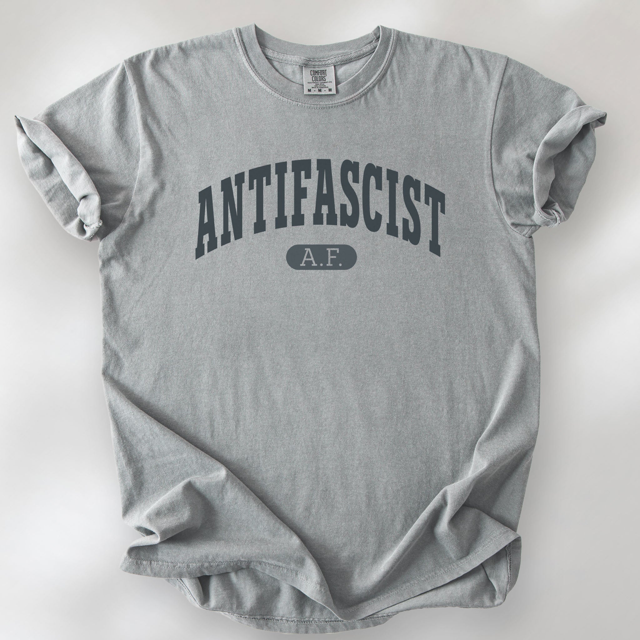 Granite Comfort Colors t-shirt with varsity collegiate style text across the front that reads "Antifascist AF."