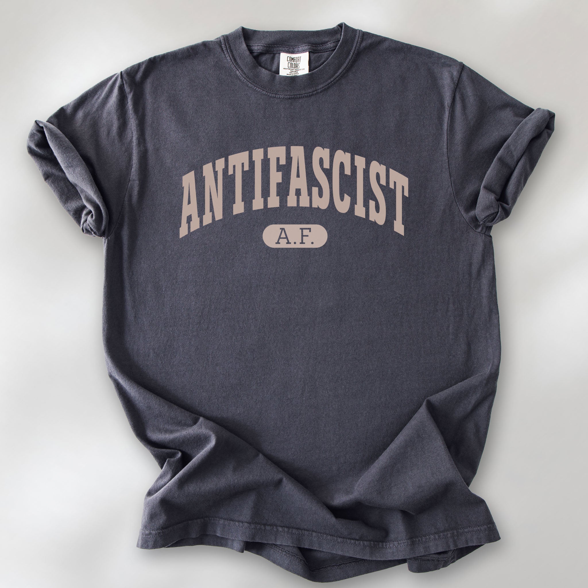 Graphite Comfort Colors t-shirt with varsity collegiate style text across the front that reads "Antifascist AF."