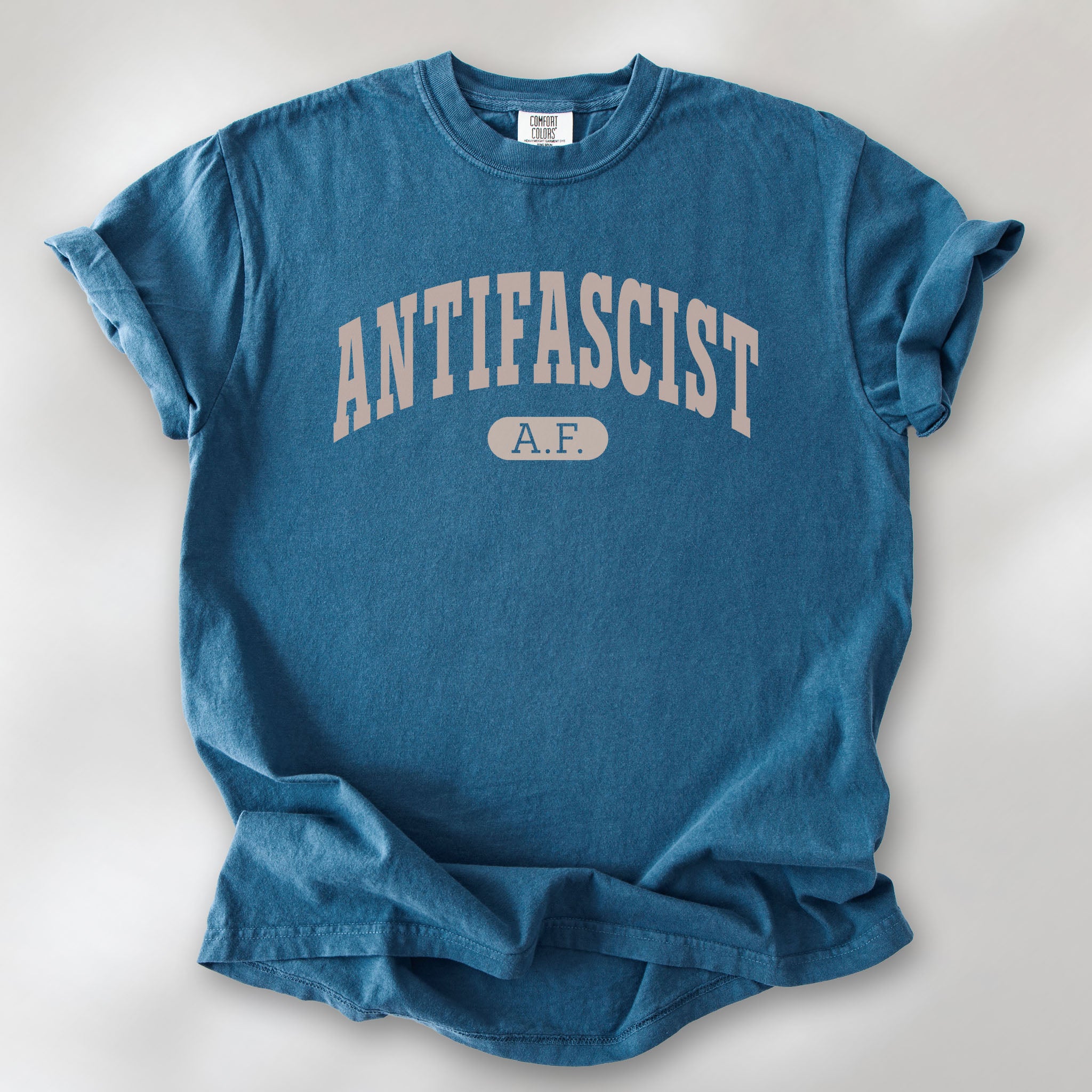 Midnight Comfort Colors t-shirt with varsity collegiate style text across the front that reads "Antifascist AF."