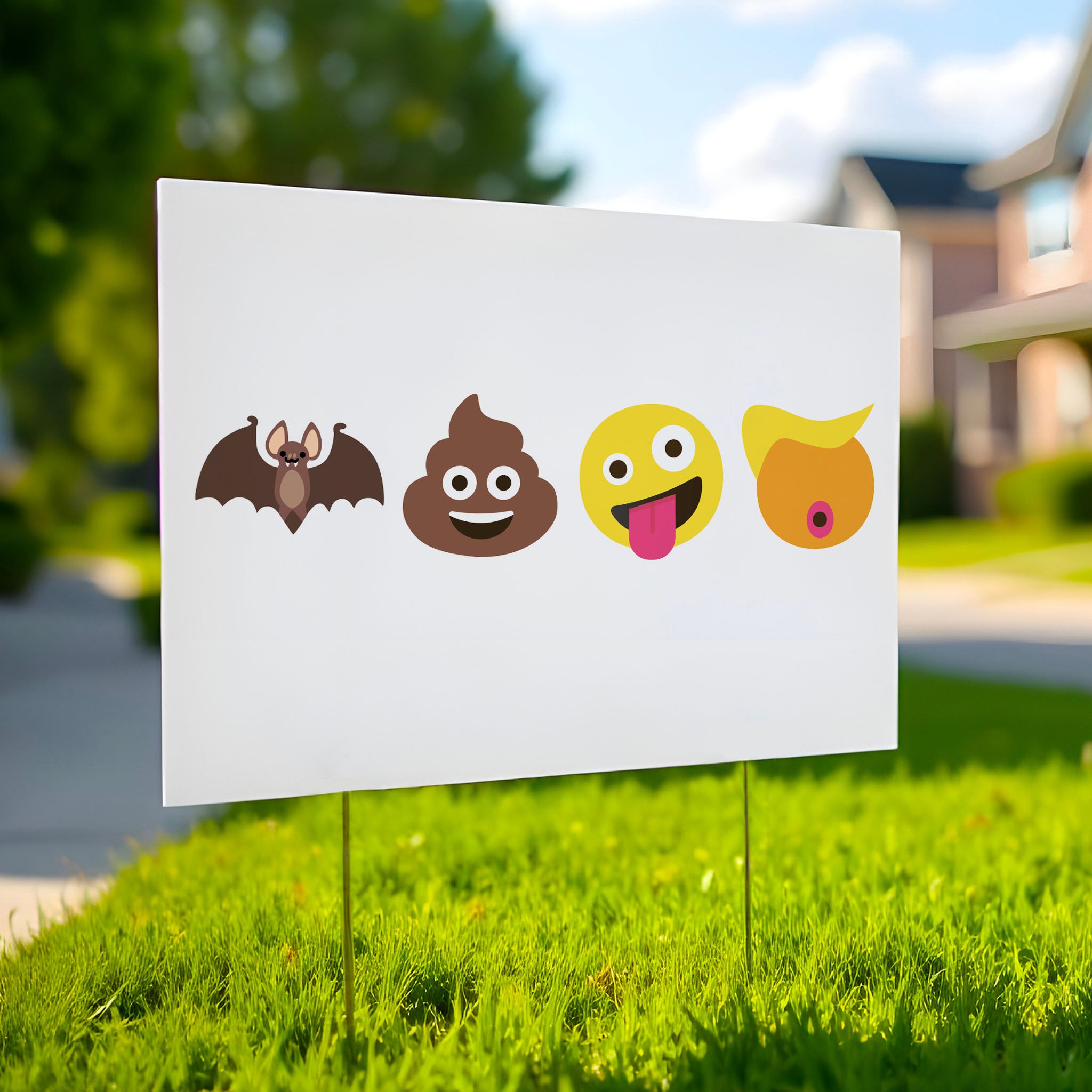 Yard sign featuring four emojis: a bat, poop, crazy face, and Trump-like orange face with yellow hair, spelling out “batshit crazy Trump” in bold visual satire, planted in a green lawn.