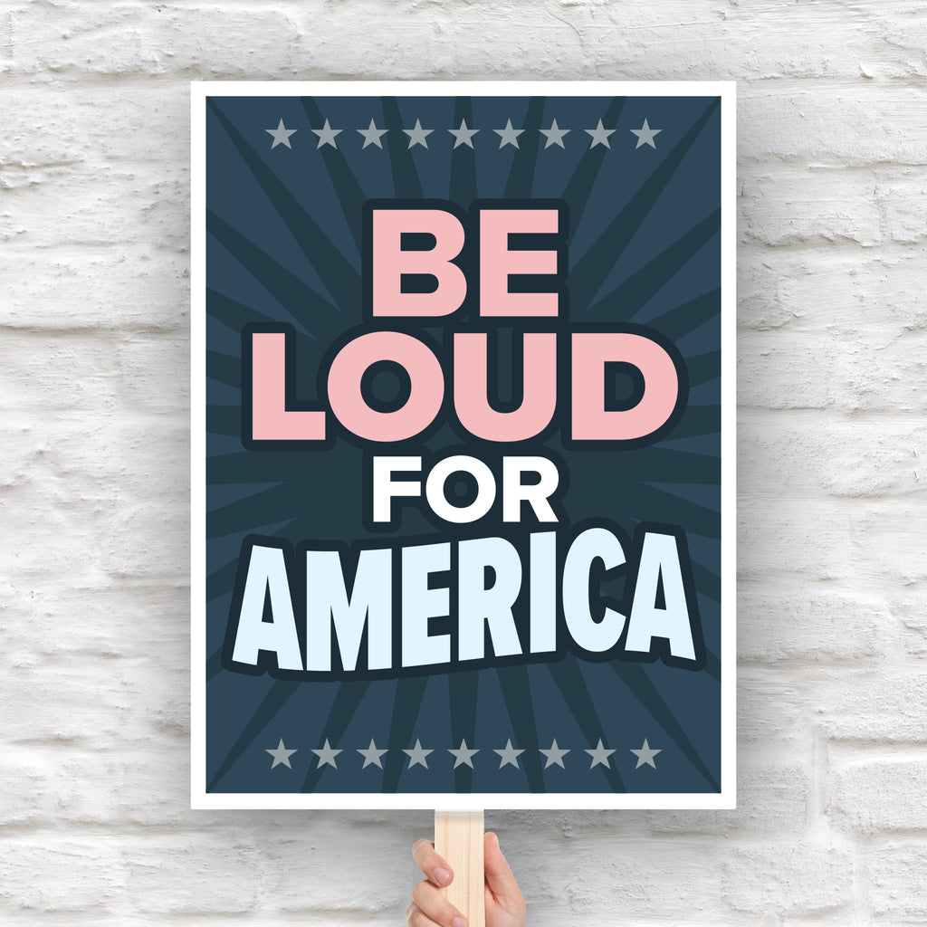 Bold protest sign with text “Be Loud for America” in patriotic colors, inspired by JB Pritzker urging people to speak up against Trump.