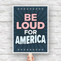 Bold protest sign with text “Be Loud for America” in patriotic colors, inspired by JB Pritzker urging people to speak up against Trump.