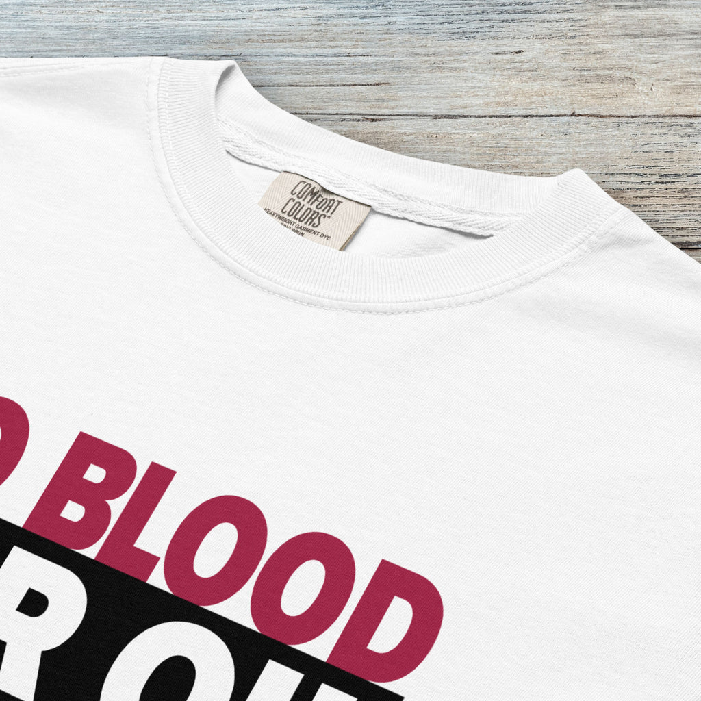 Closeup detail of white protest t-shirt with bold text reading “No Blood for Oil” and dripping oil graphic, anti-war political shirt.