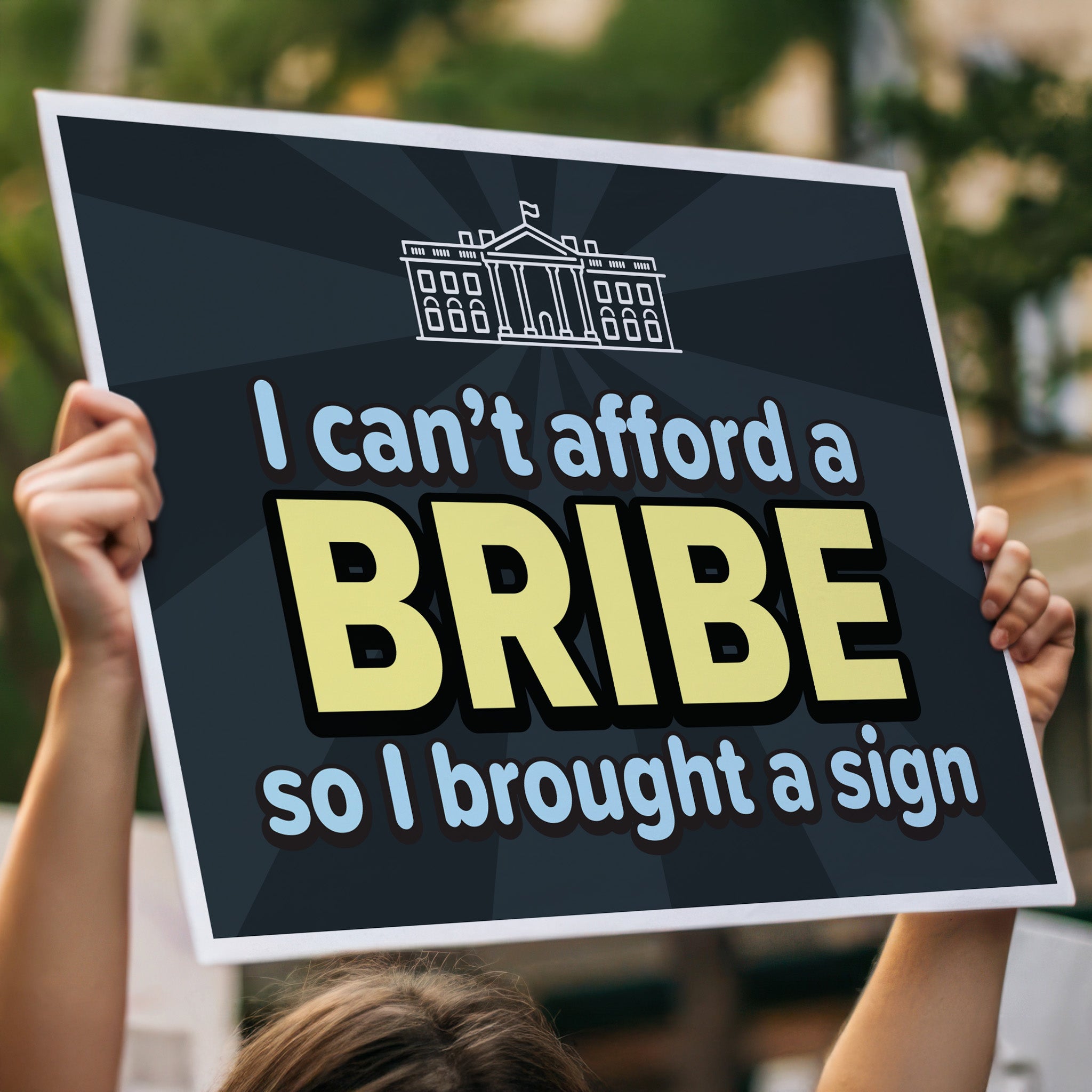 Person holding protest sign with a dark blue background and blue and yellow text that reads "I can't afford a bribe so I brought a sign" with an illustration of the White House, a condemnation of Trump's corruption.