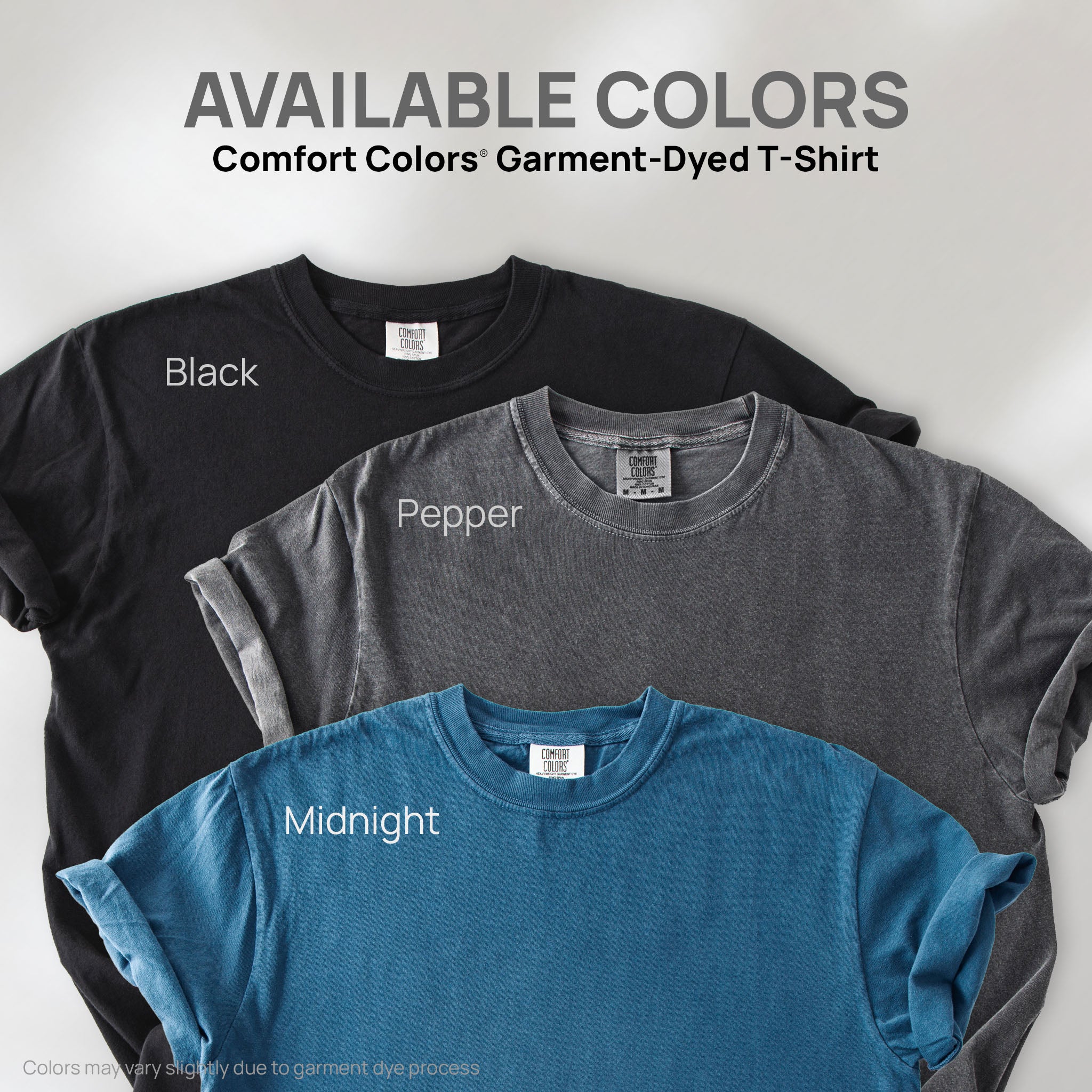 Three shirts showing the available colors for this Comfort Colors Garment-Dyed T-Shirt: pepper, black, and midnight.
