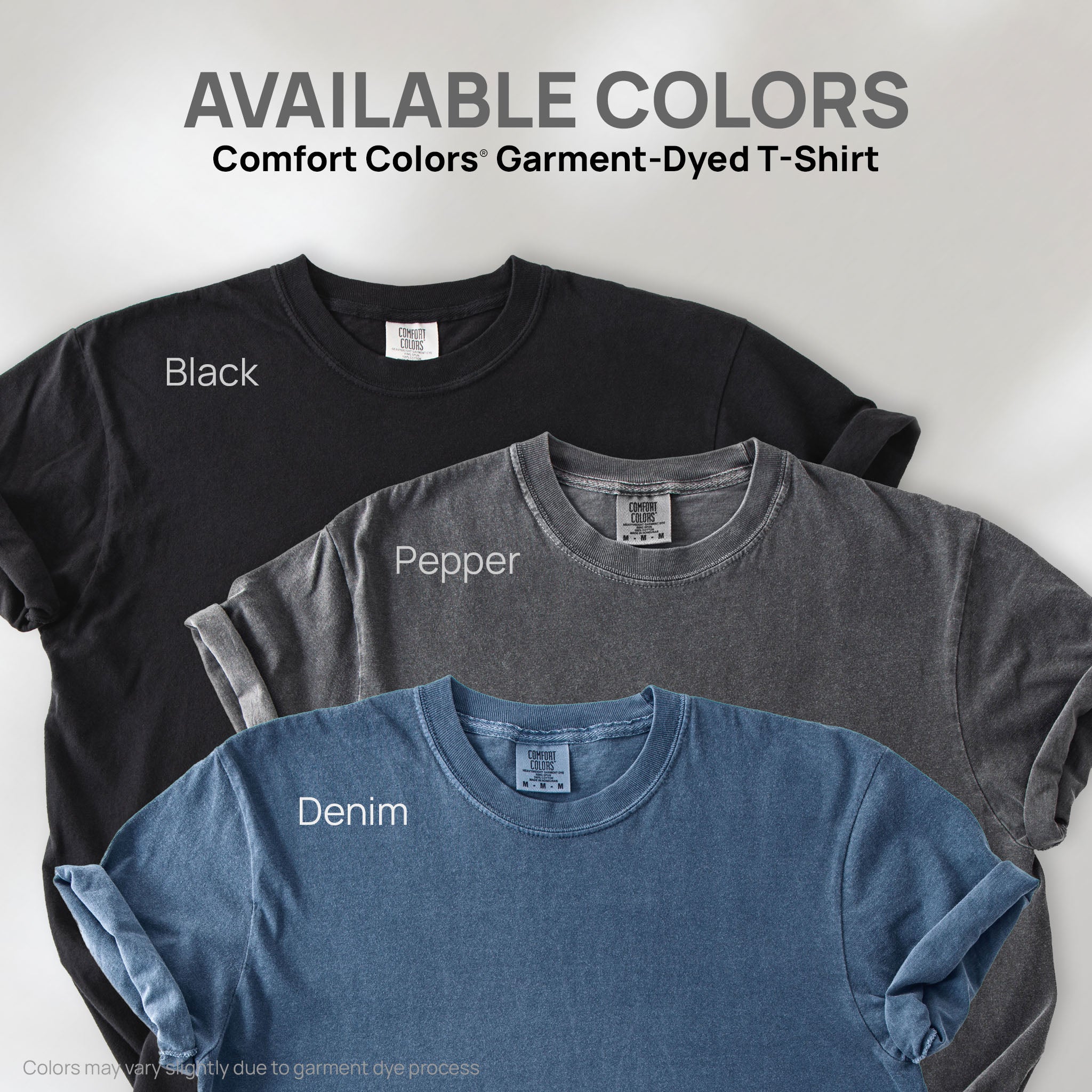 Three shirts showing the available colors for this Comfort Colors Garment-Dyed T-Shirt: pepper, black, and denim.
