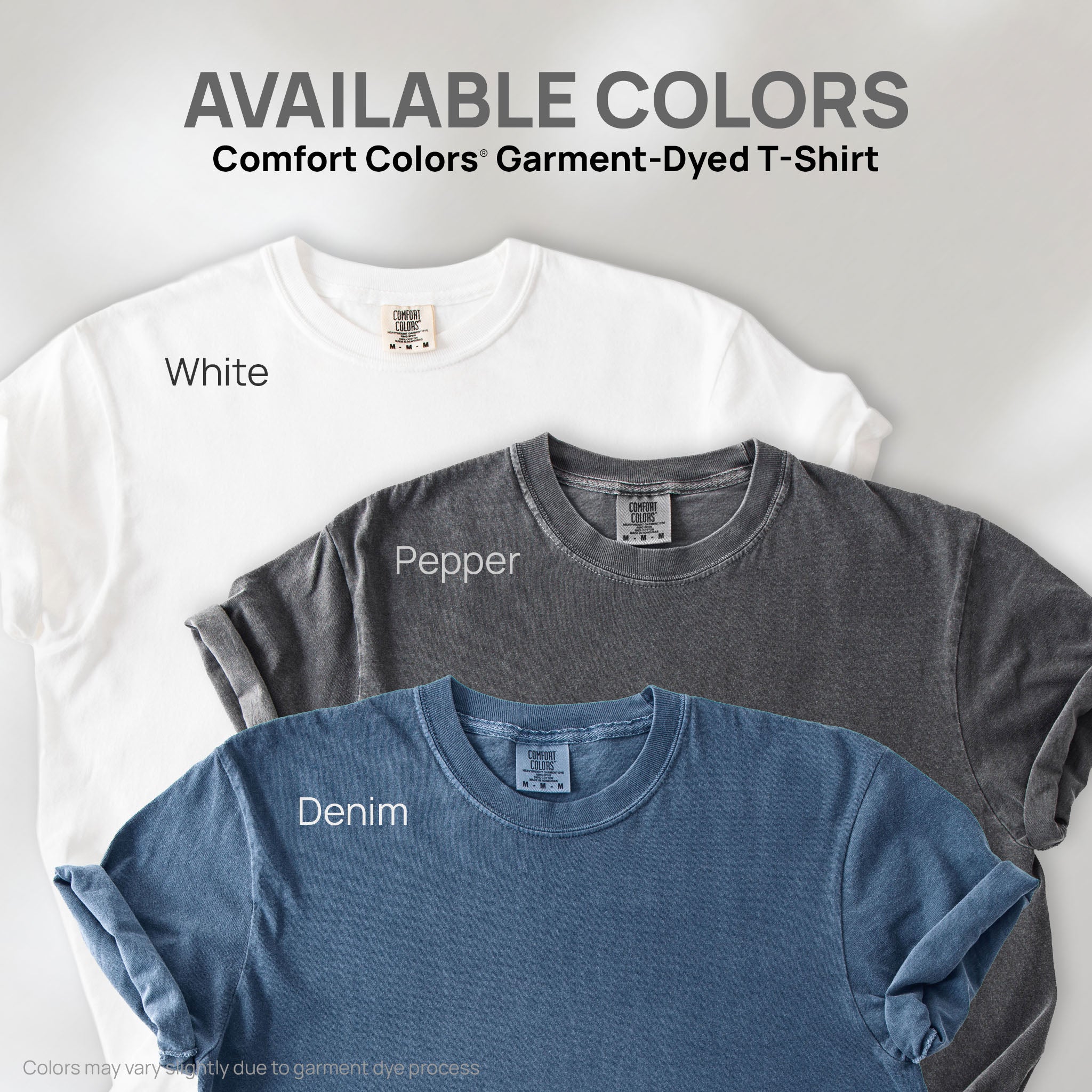 Three shirts showing the available colors for this Comfort Colors Garment-Dyed T-Shirt: pepper, black, and denim.
