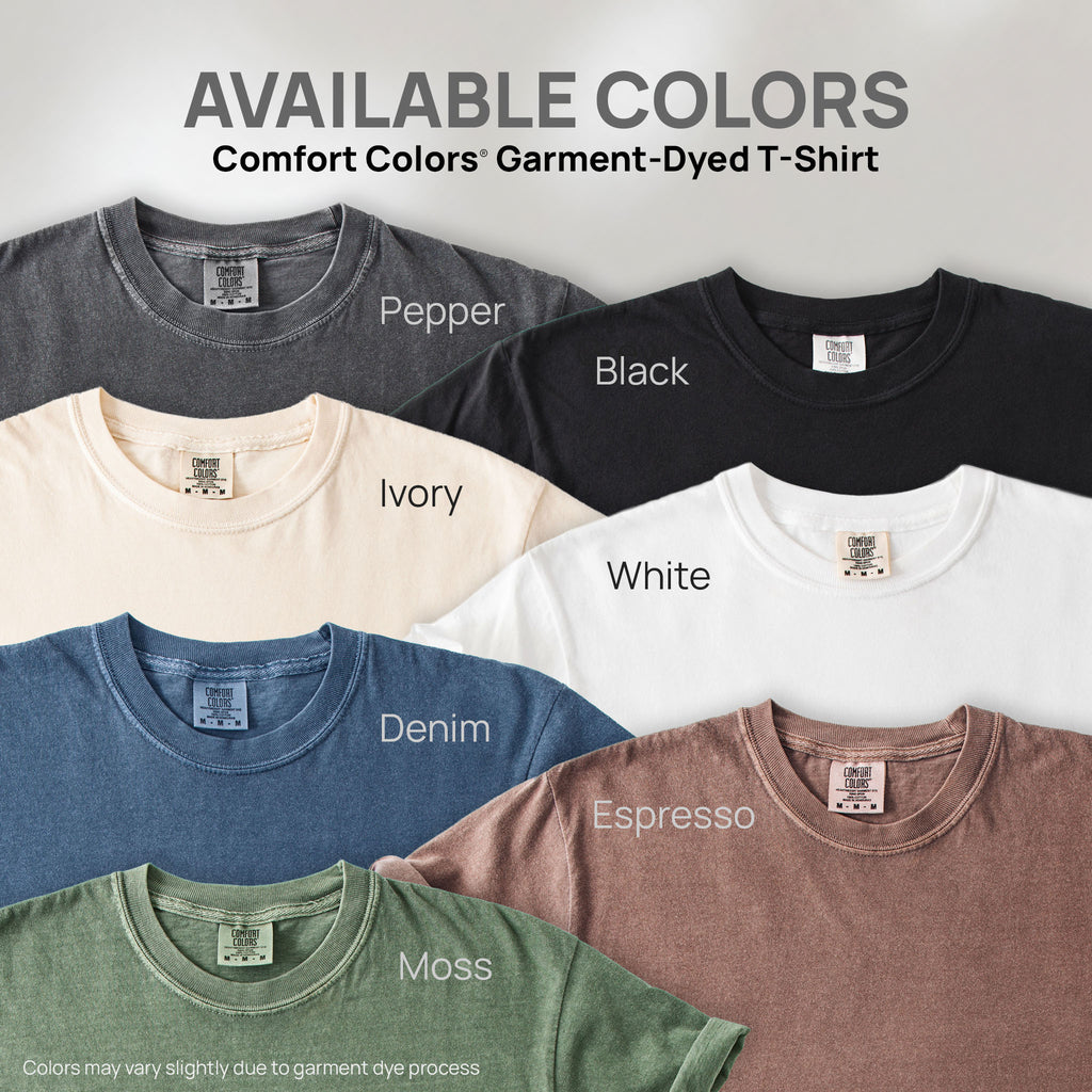 Seven shirts showing the available colors for this Comfort Colors Garment-Dyed T-Shirt: pepper, black, white, ivory, denim, espresso, moss.
