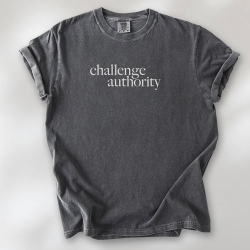 Pepper t-shirt with minimalist serif text block reading “challenge authority."