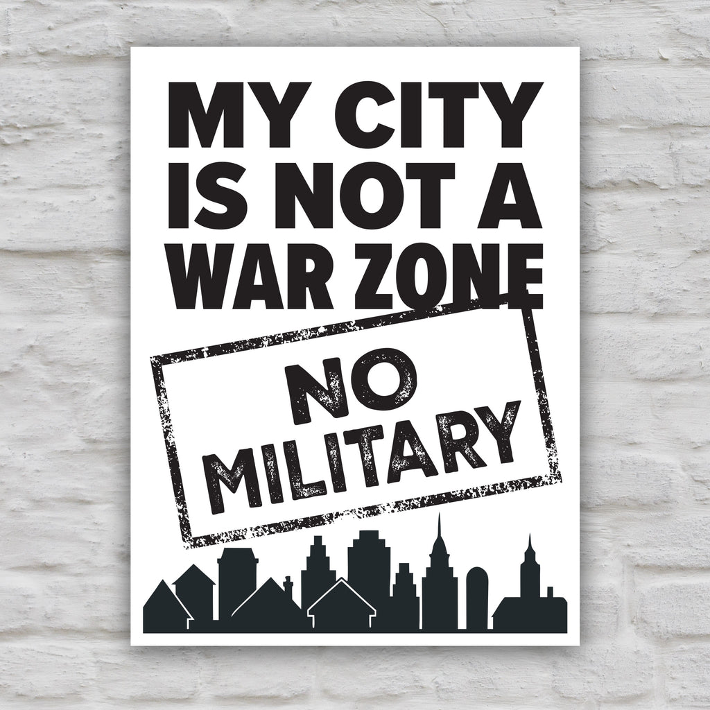 Black and white version of sign that reads "My City Is Not a War Zone – No Military" with bold lettering and a city skyline silhouette, anti-Trump political art.