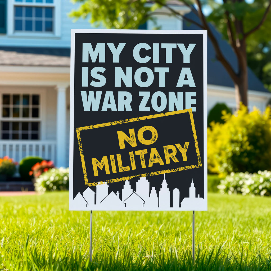 Yard sign that reads "My City Is Not a War Zone – No Military" with bold lettering and a city skyline silhouette, anti-Trump political art, planted in a green lawn.