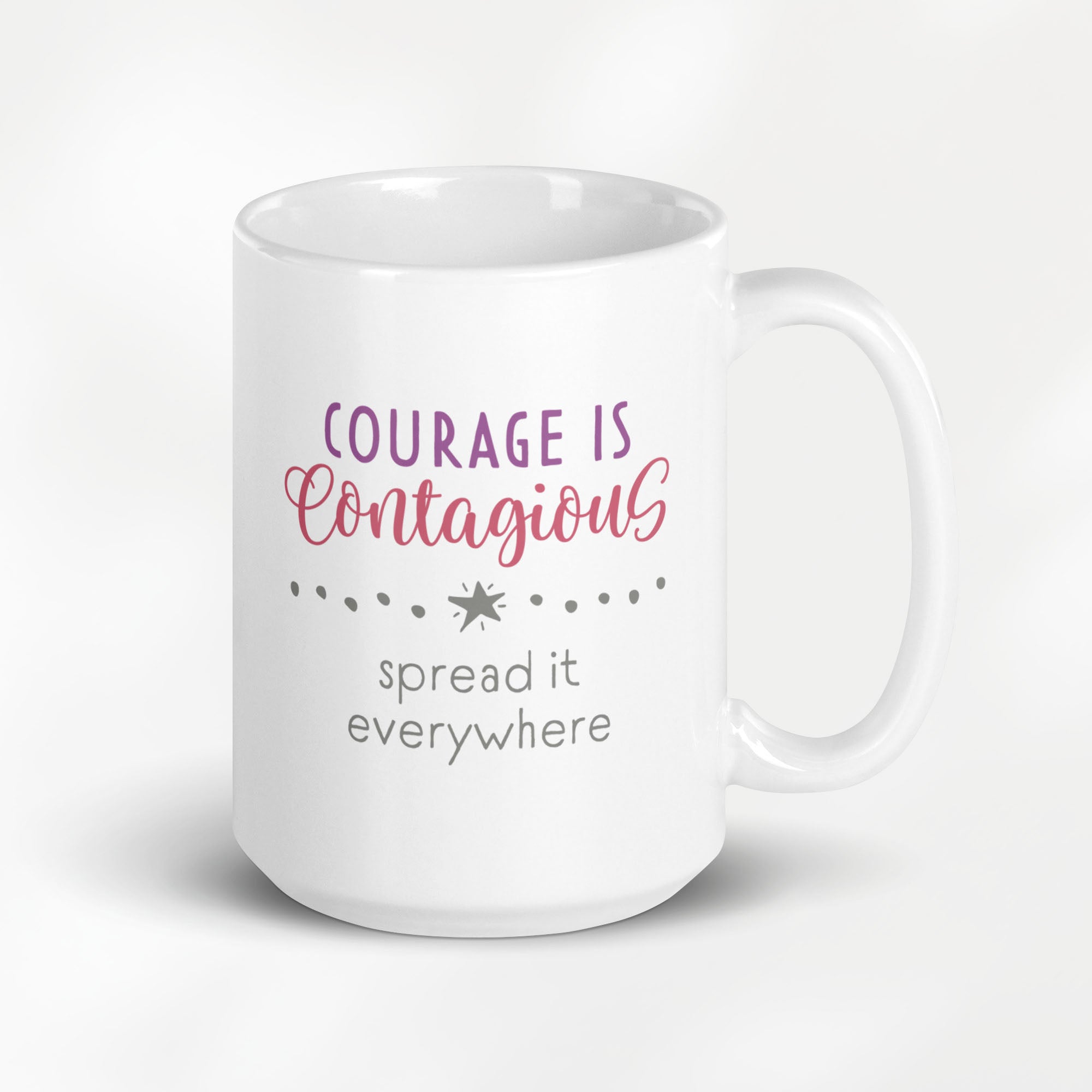 15 ounce white ceramic mug with styled text graphic that reads "courage is contagious – spread it everywhere".