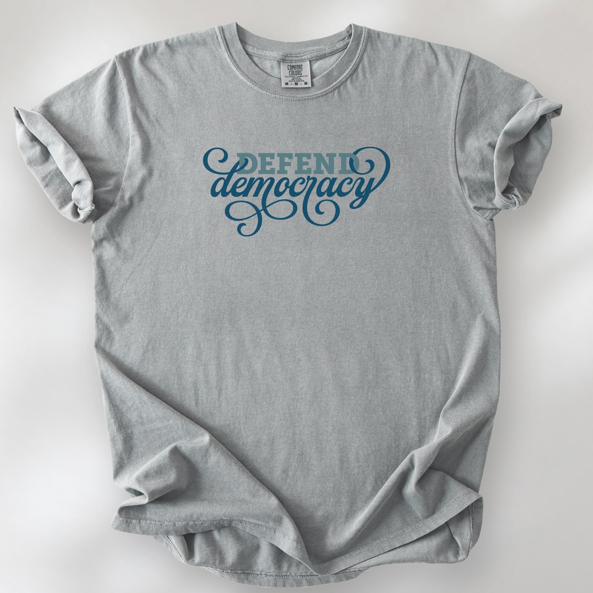Granite t-shirt with blue slab and script text reading “Defend Democracy.”