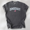 Pepper t-shirt with varsity-style graphic that says "democracy" with a USA flag beneath it.