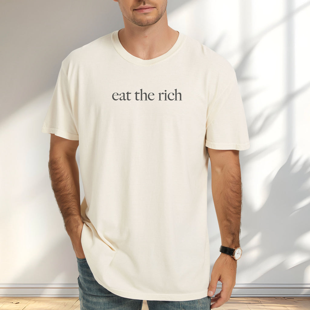 Male model wearing ivory t-shirt with minimalist dark grey text reading “eat the rich."