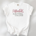 White t-shirt with stylized text reading “Abolish the Electoral College” in muted red and gray, minimalist pro-democracy design.