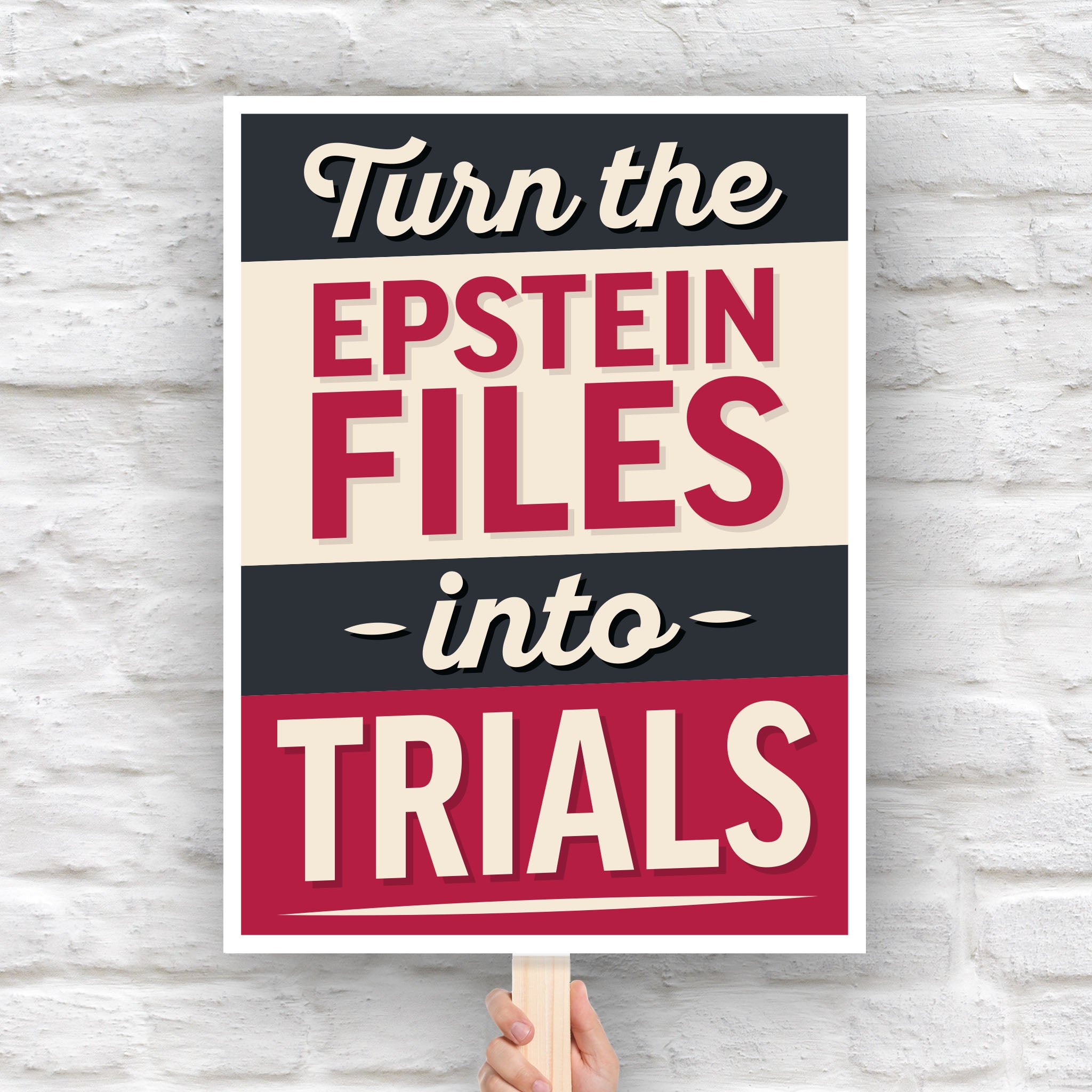 Protest sign reading “Turn the Epstein Files Into Trials” in bold retro lettering.