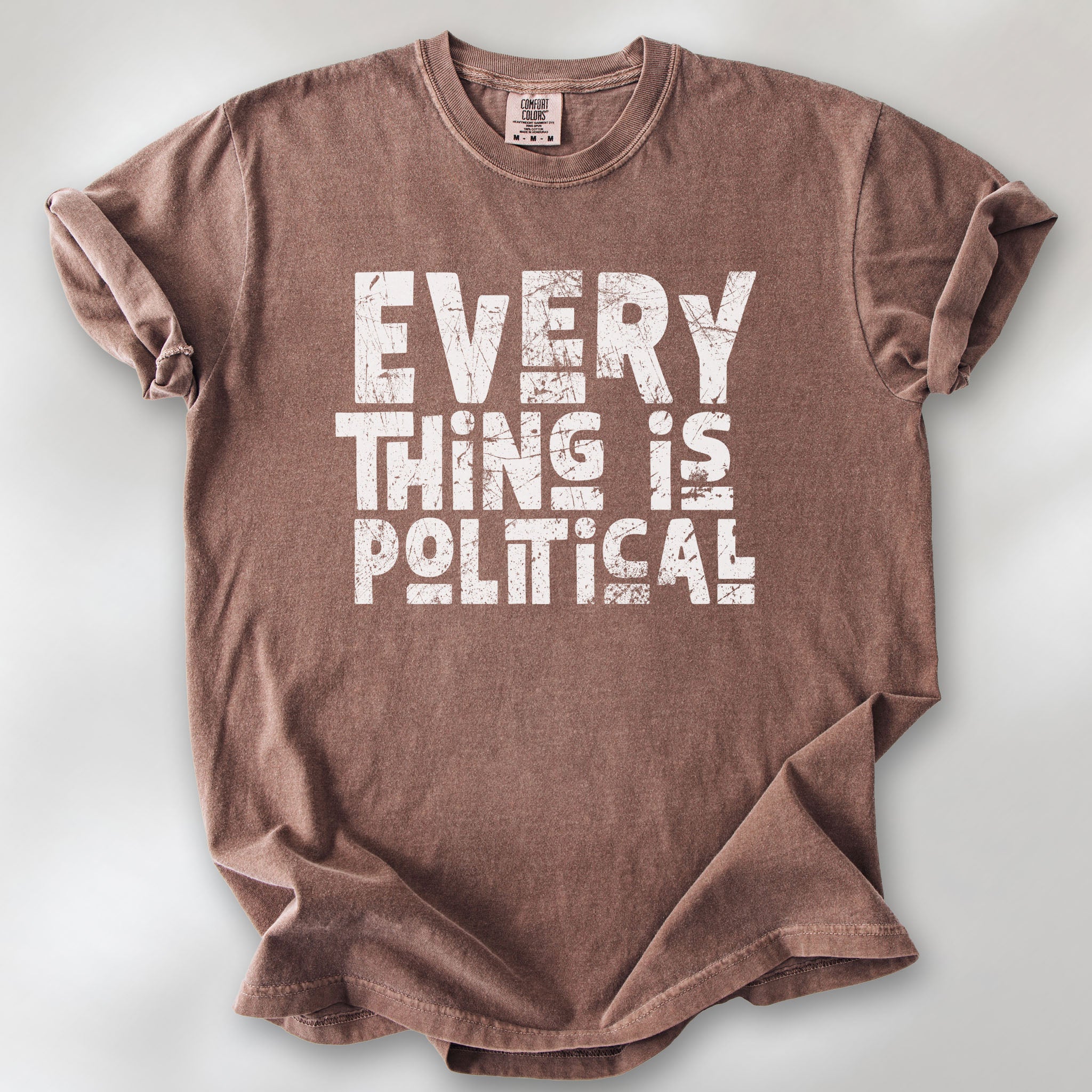 Espresso t-shirt featuring distressed block typography reading "Everything Is Political" in a bold minimalist design.