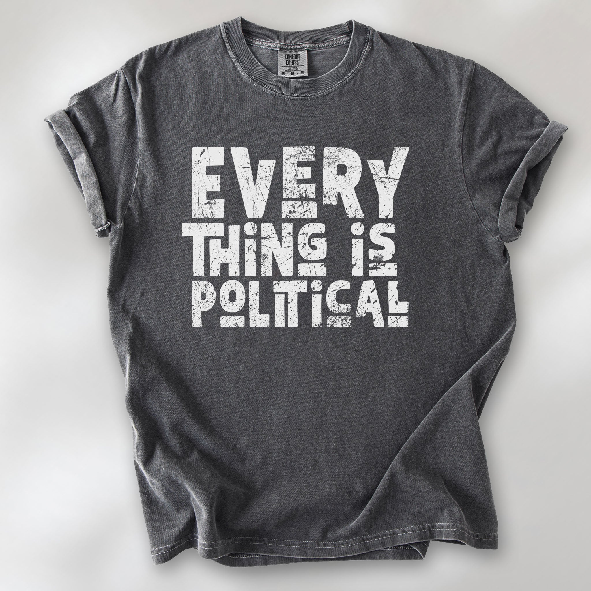 Pepper t-shirt featuring distressed block typography reading "Everything Is Political" in a bold minimalist design.