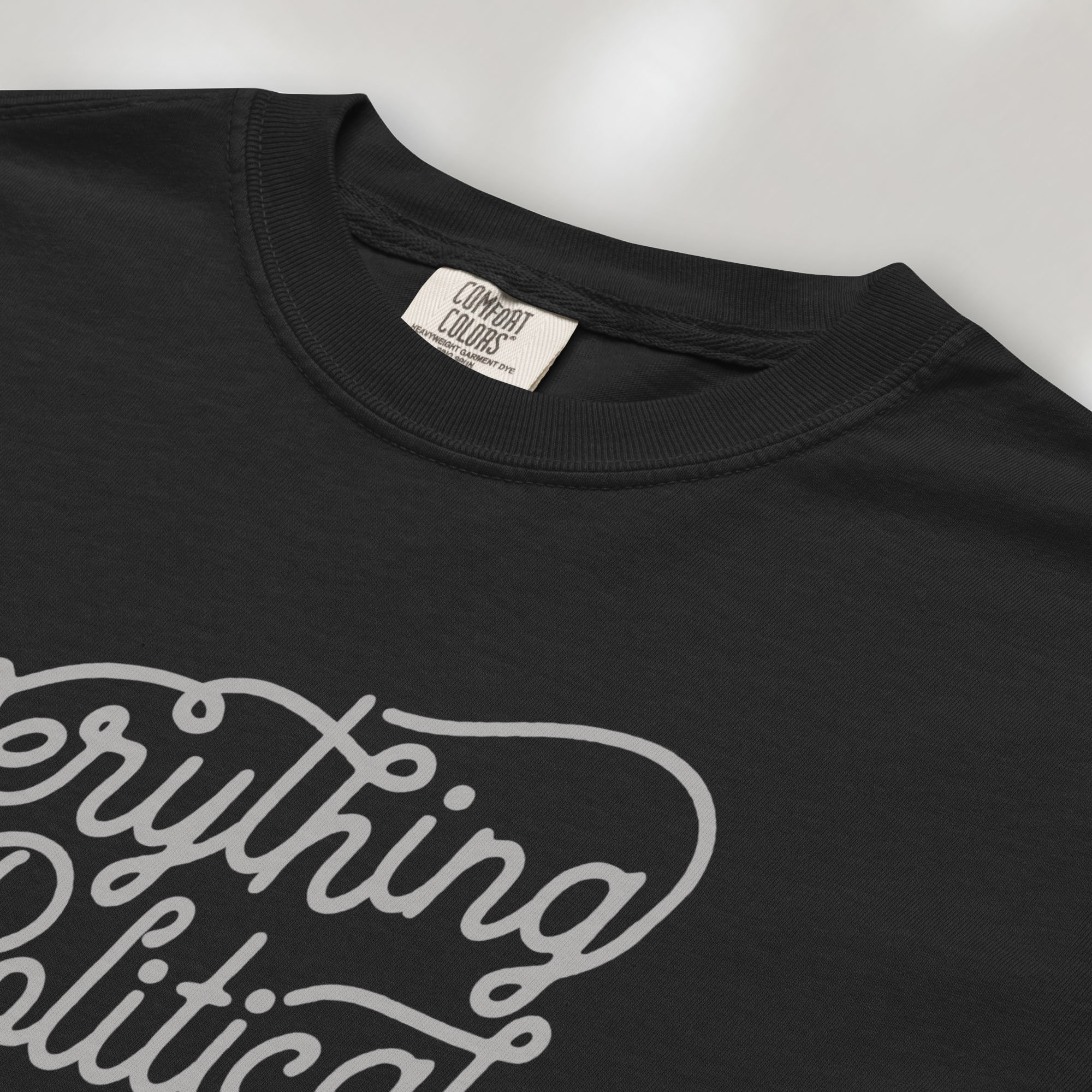 Closeup detail of black minimalist script everything is political activist shirt.