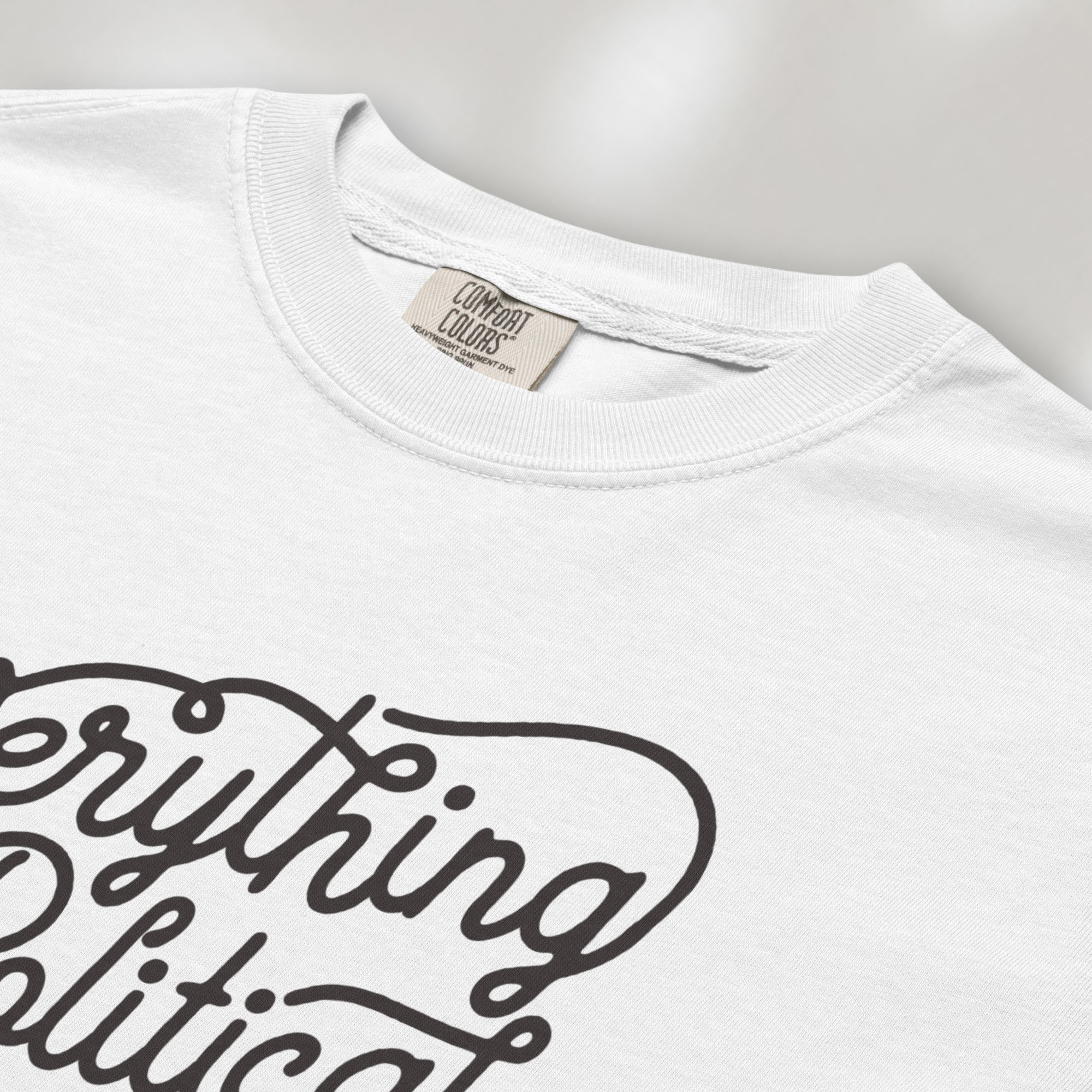 Closeup detail of white minimalist script everything is political activist shirt.