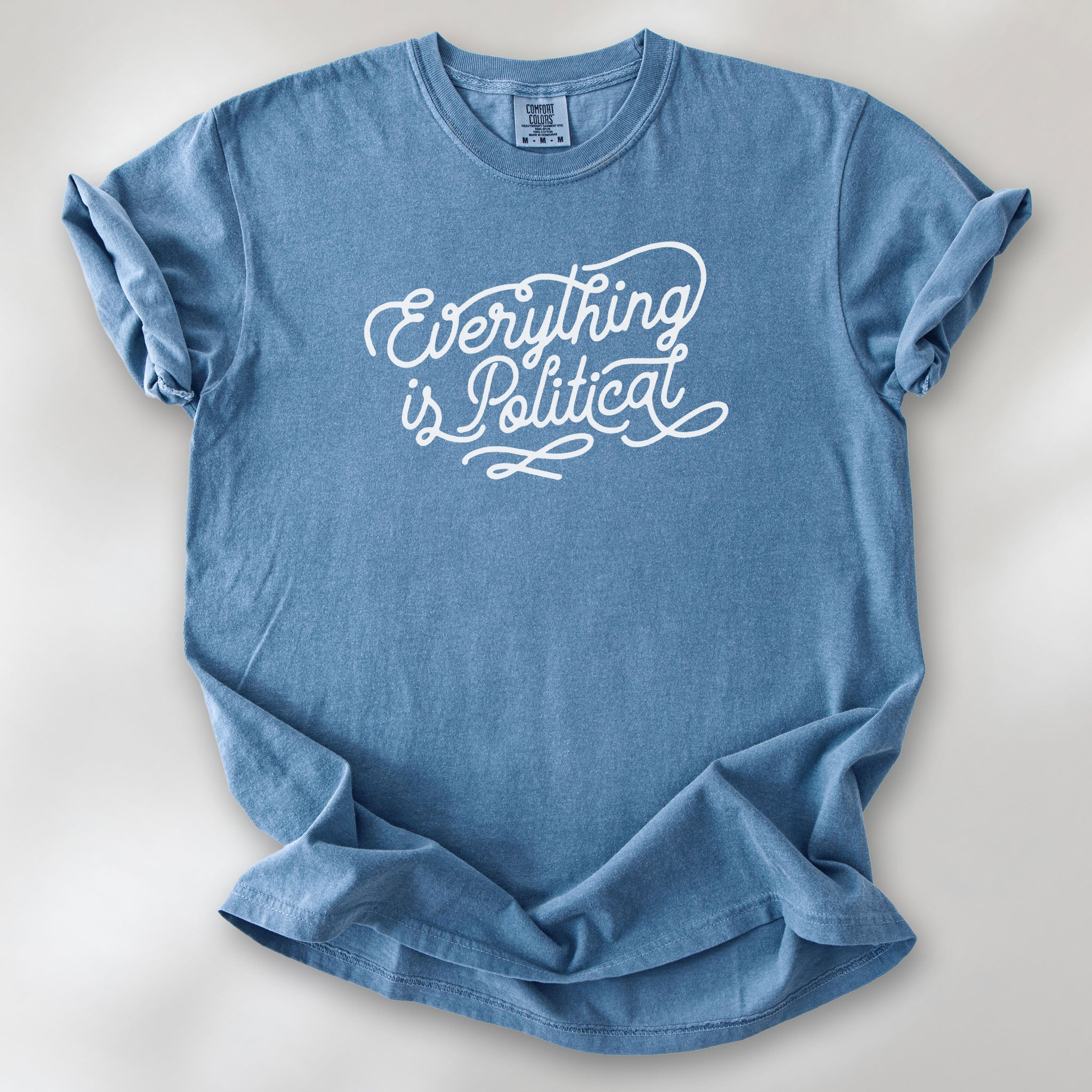 Blue jean shirt with minimalist script "everything is political" graphic.
