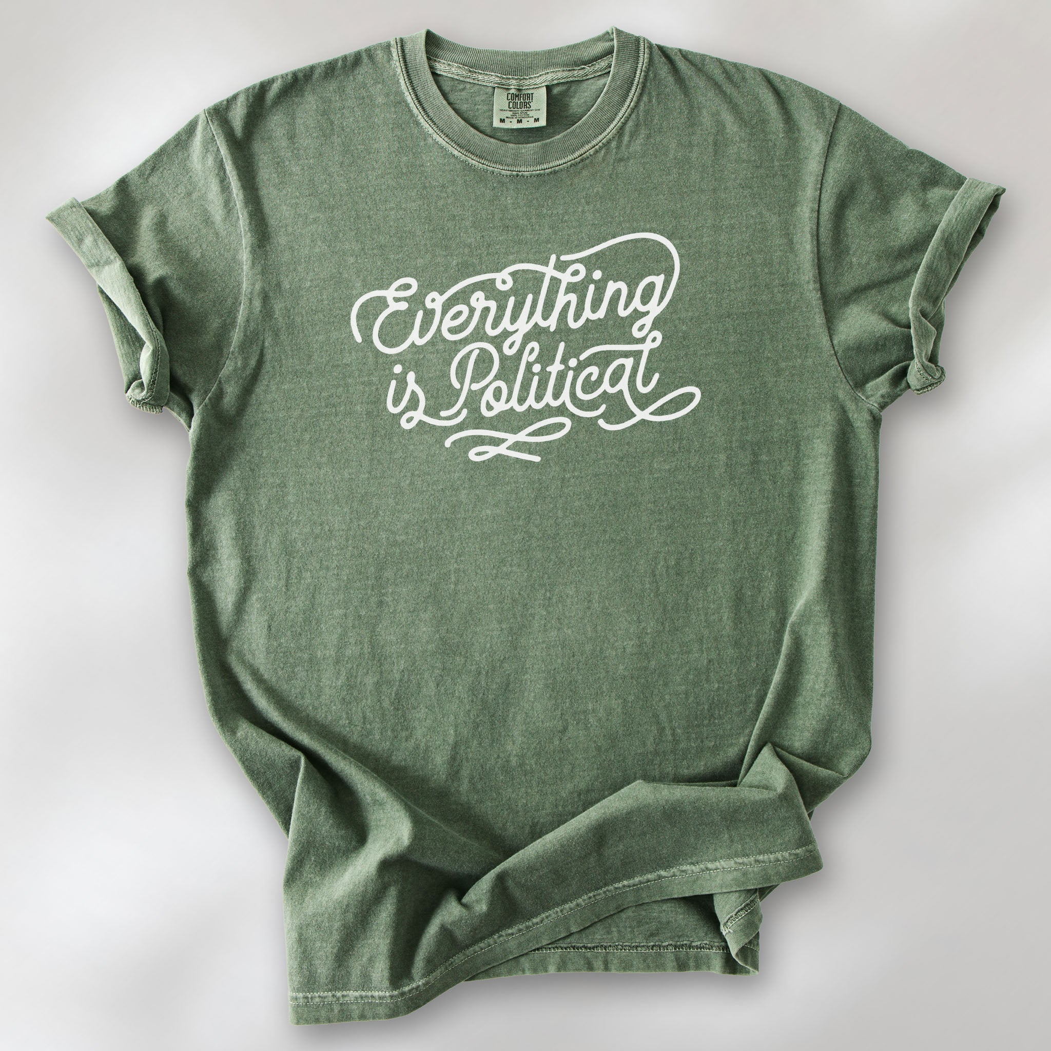 Moss shirt with minimalist script "everything is political" graphic.