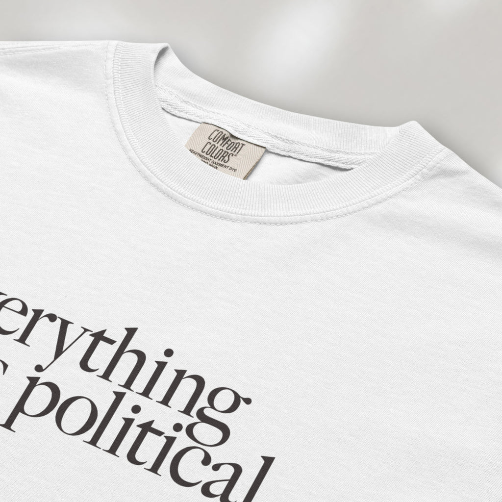 Closeup detail of white unisex t-shirt with minimalist serif gray text reading “everything is political."