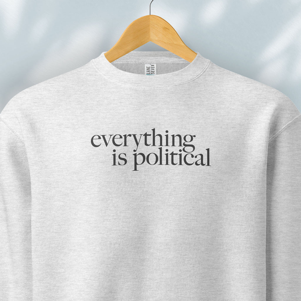 Hanging grey sweatshirt with minimalist serif gray text reading “everything is political."