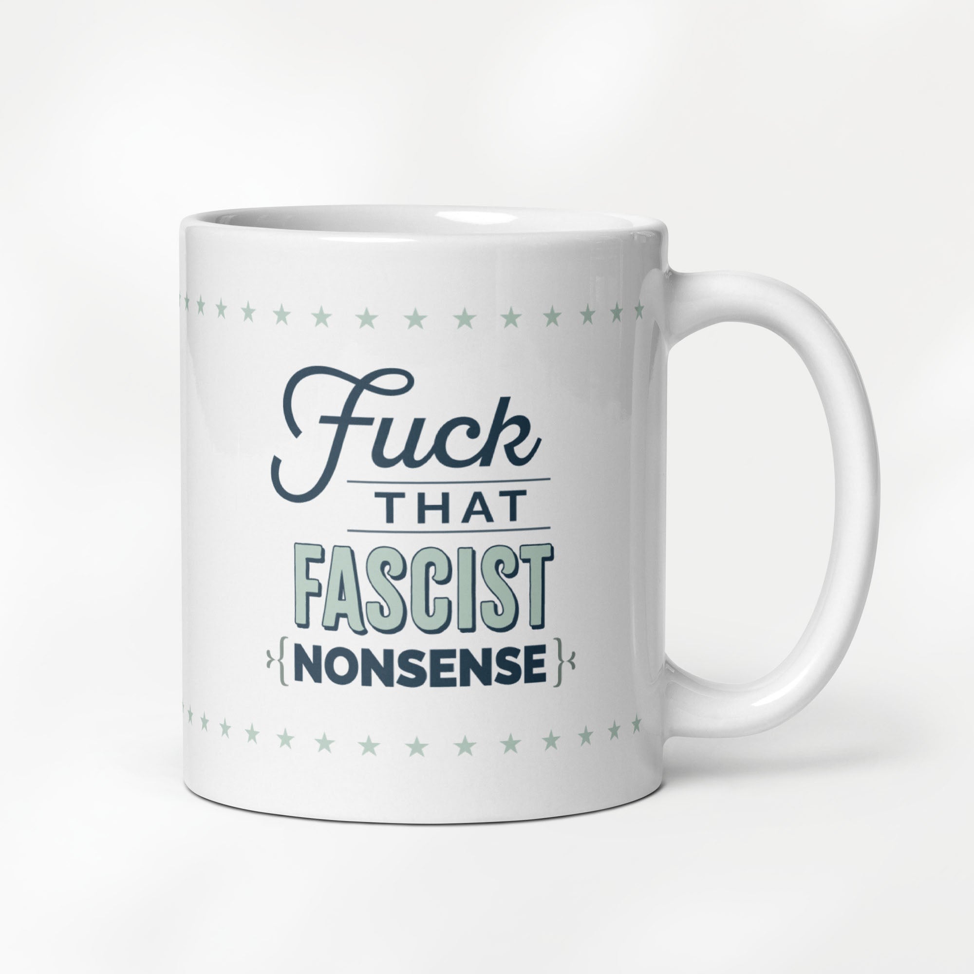 11 ounce ceramic mug with stylized graphic that reads "fuck that fascist nonsense".