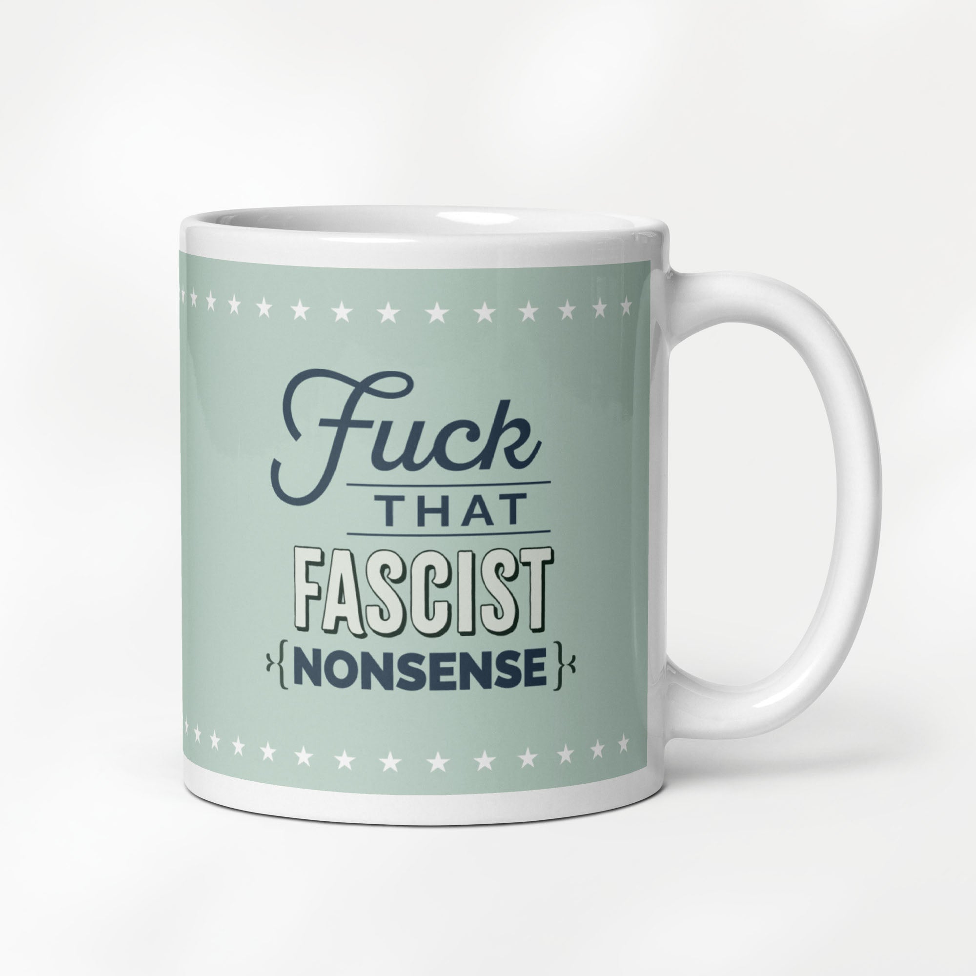 11 ounce ceramic mug with graphic on mint green background and navy styled text block that reads "fuck that fascist nonsense." 