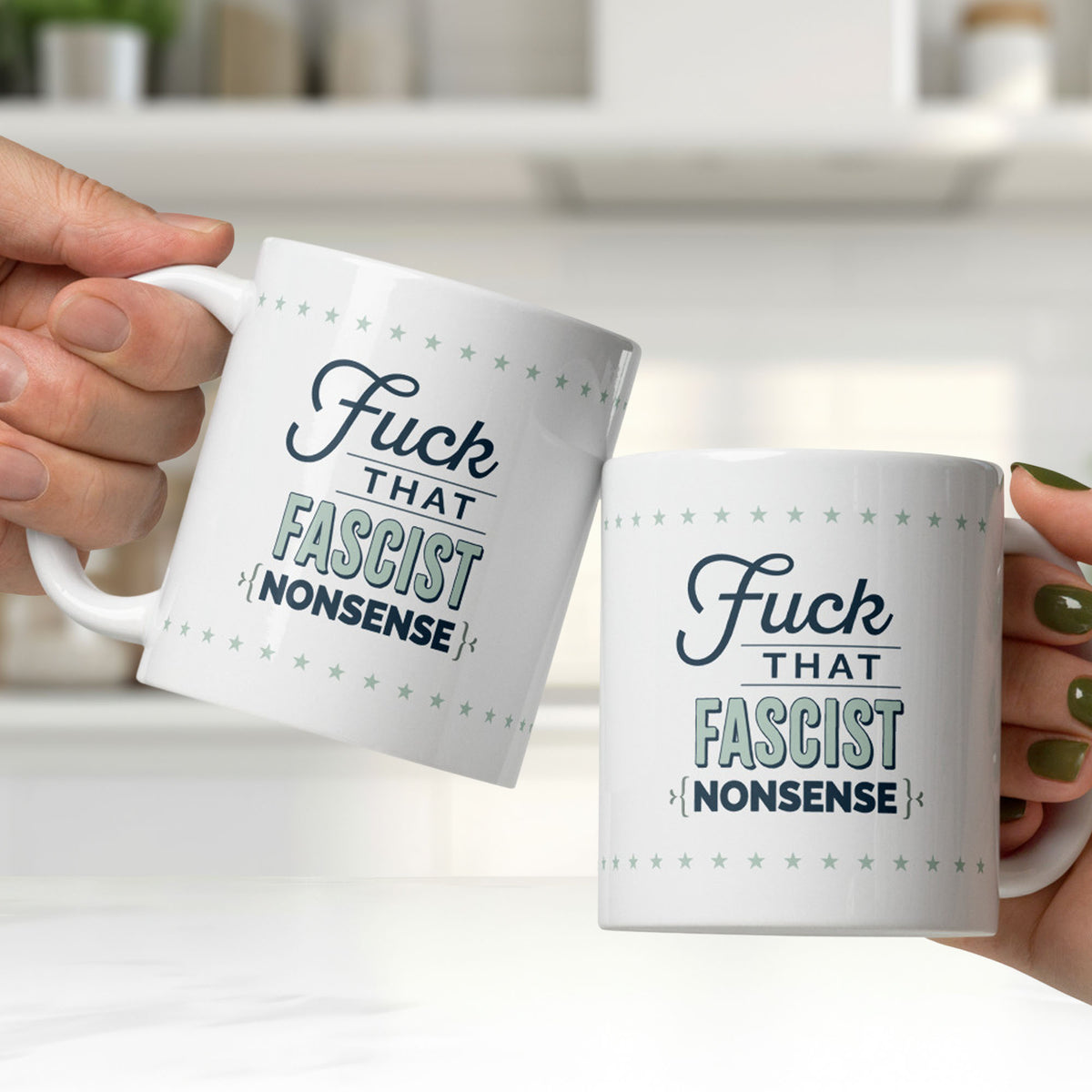 Two mugs being clinked together by two people in a bright white kitchen. Mug reads "fuck that fascist nonsense" in stylized text block.