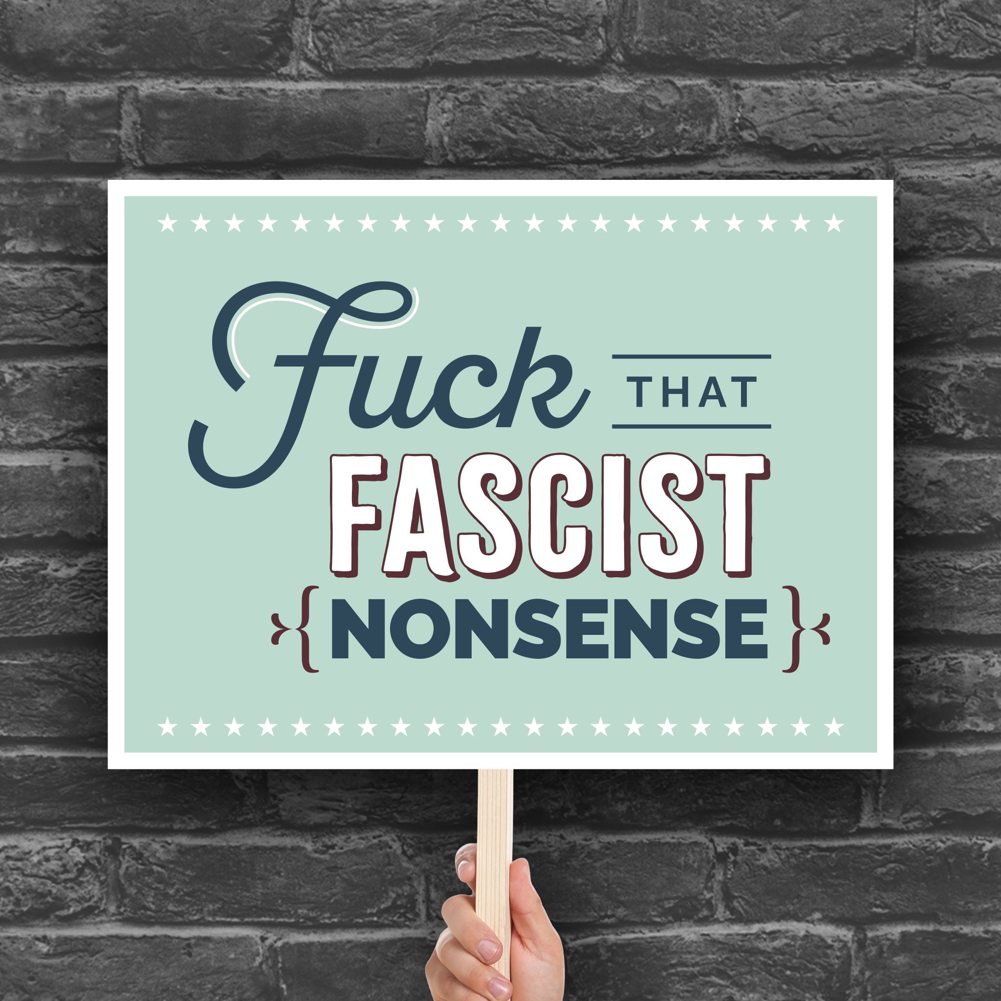 Anti-trump protest sign with stylized text design that reads "Fuck that fascist nonsense."